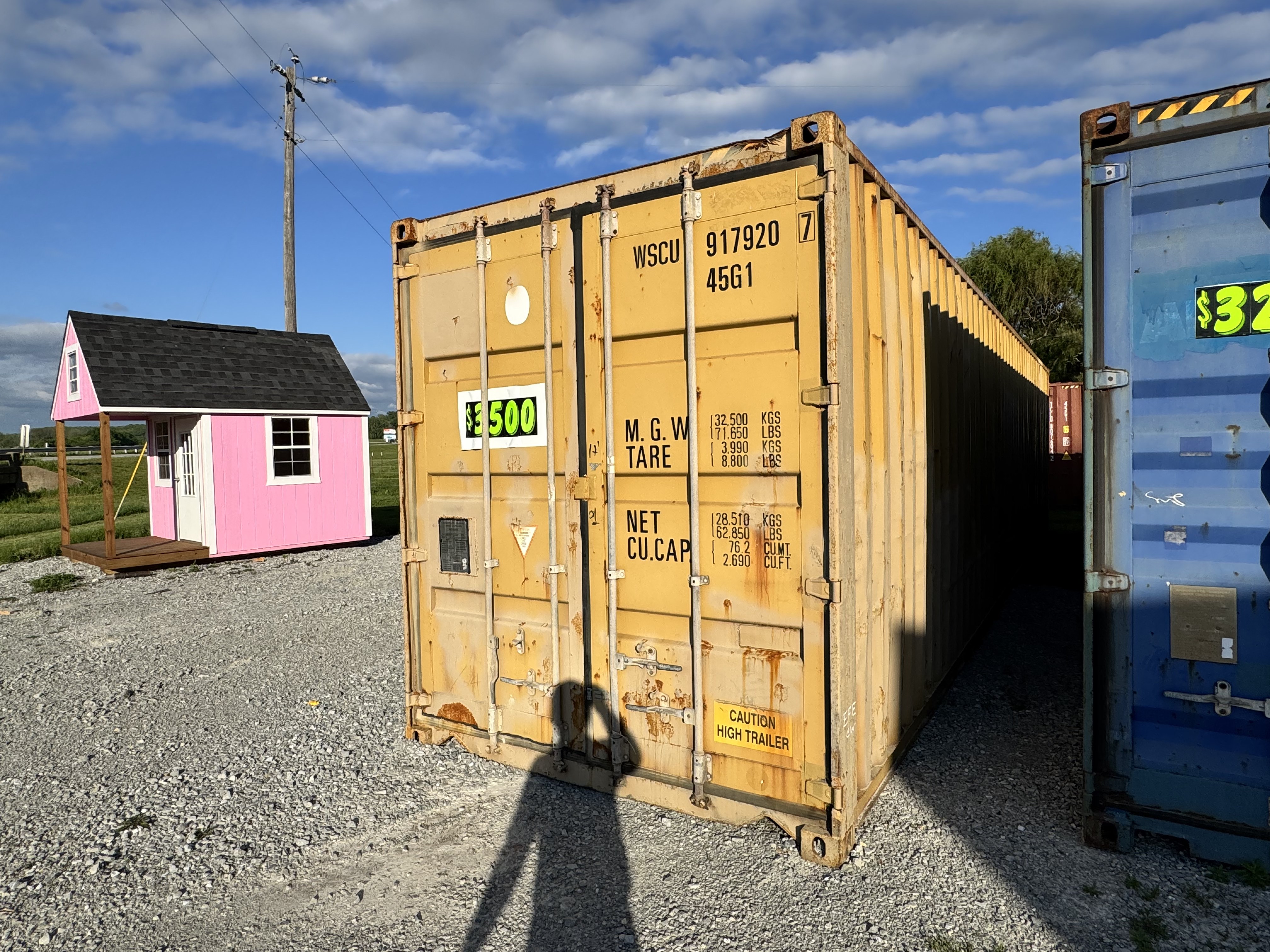 Cargo-worthy shipping container with end doors and a clear work area