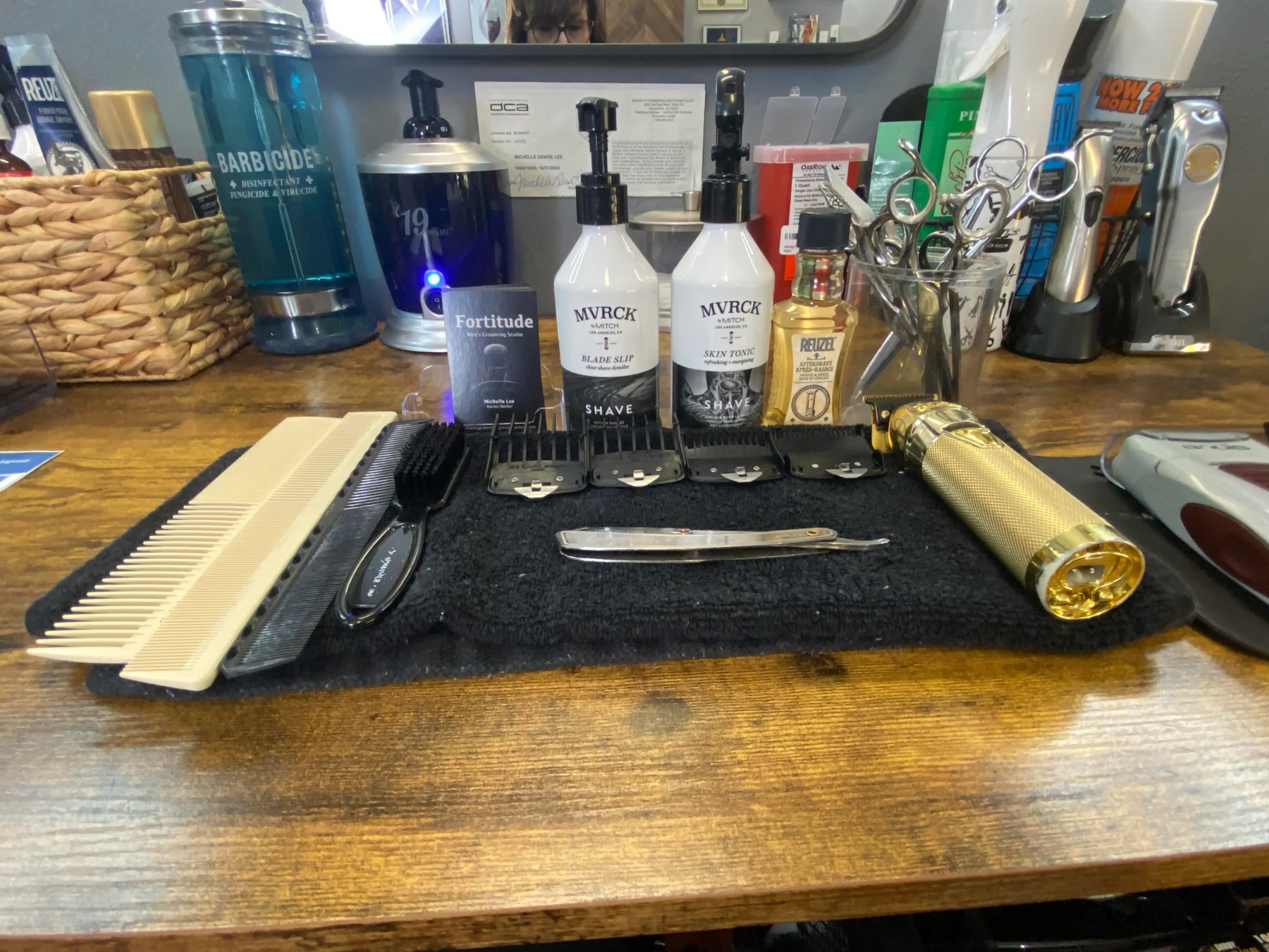 Fortitude barber workstation with disinfected tools, scissors, combs, clippers, and grooming products