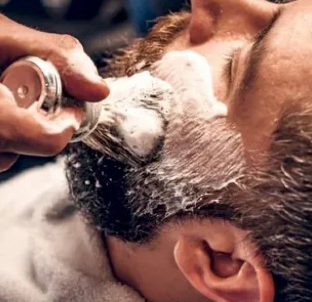 A man receiving a straight razor shave