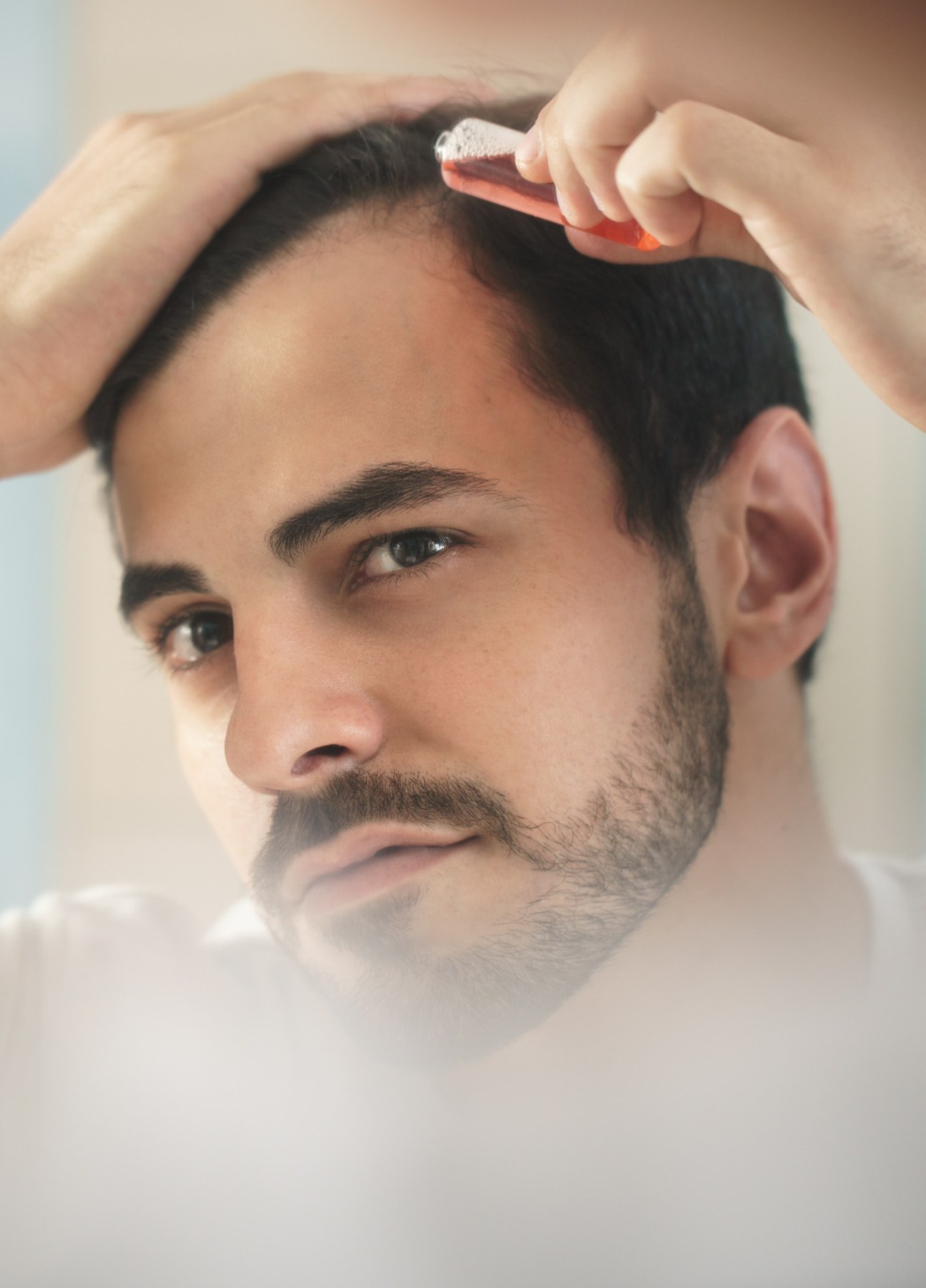 Man treating his hair for hair loss