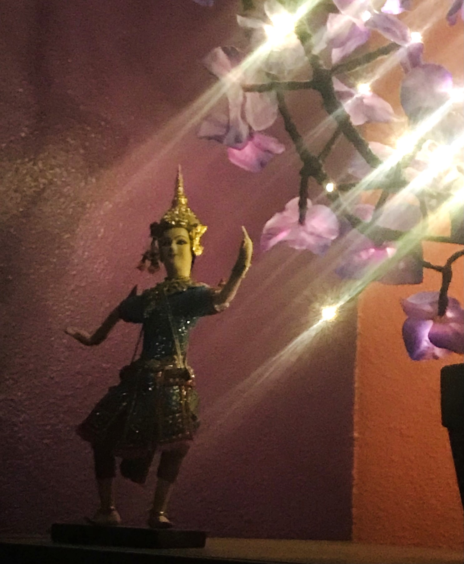 Decorative statue and blossom lights inside Arize