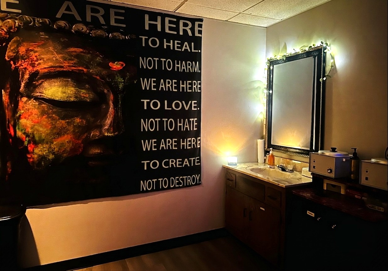 Arize’s spa interior with an illuminated mirror and wall hanging