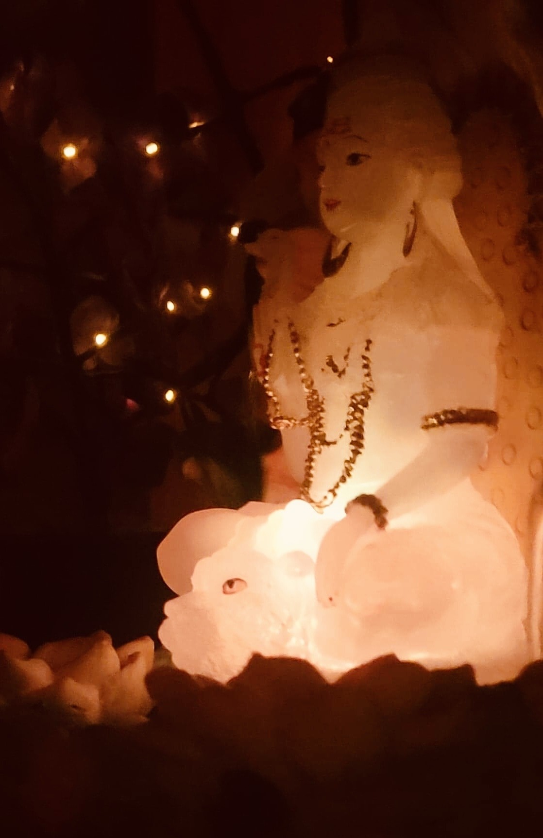 Warmly illuminated decorative statue and soft lights inside Arize