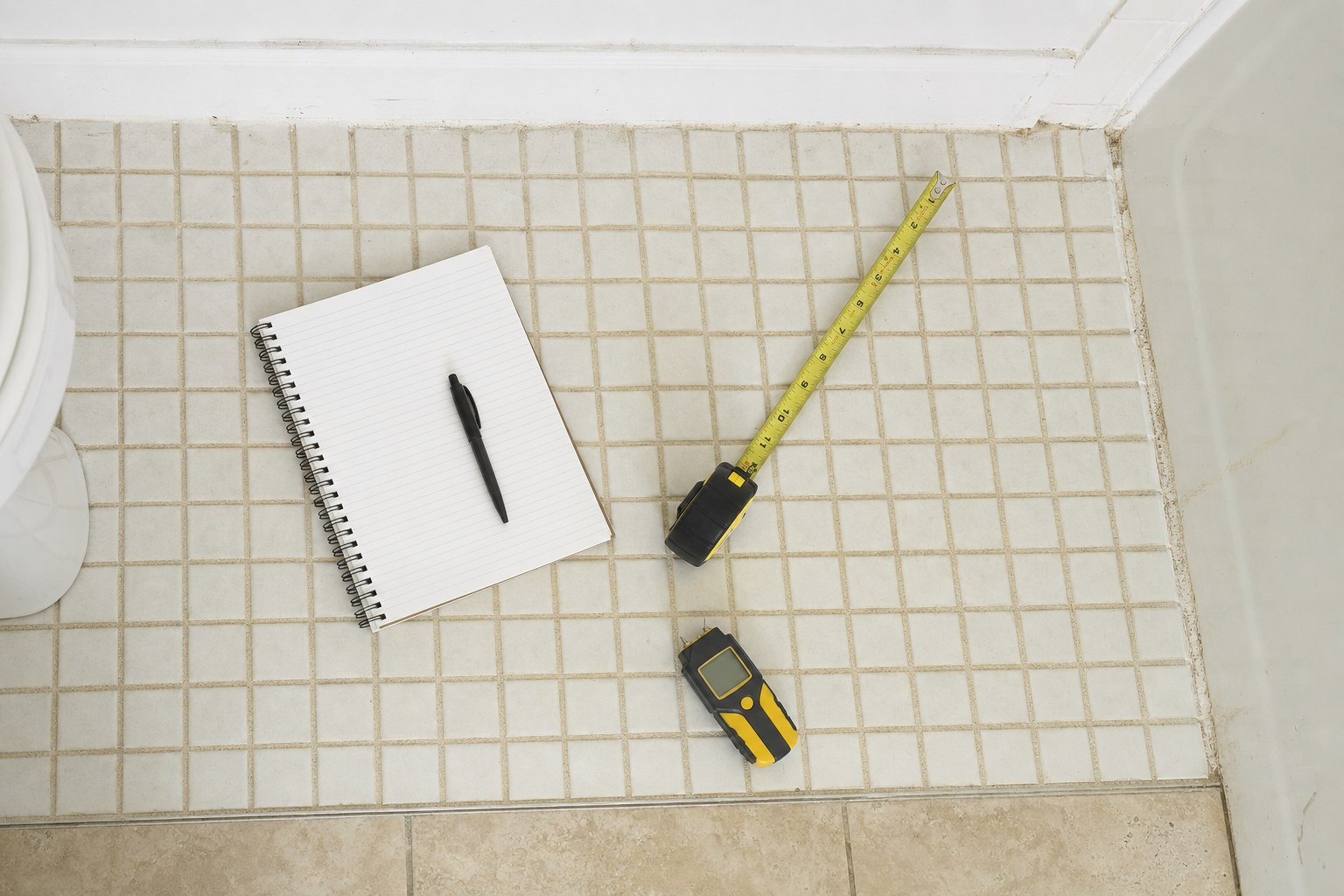 Measuring tools and condition notes in an existing bathroom