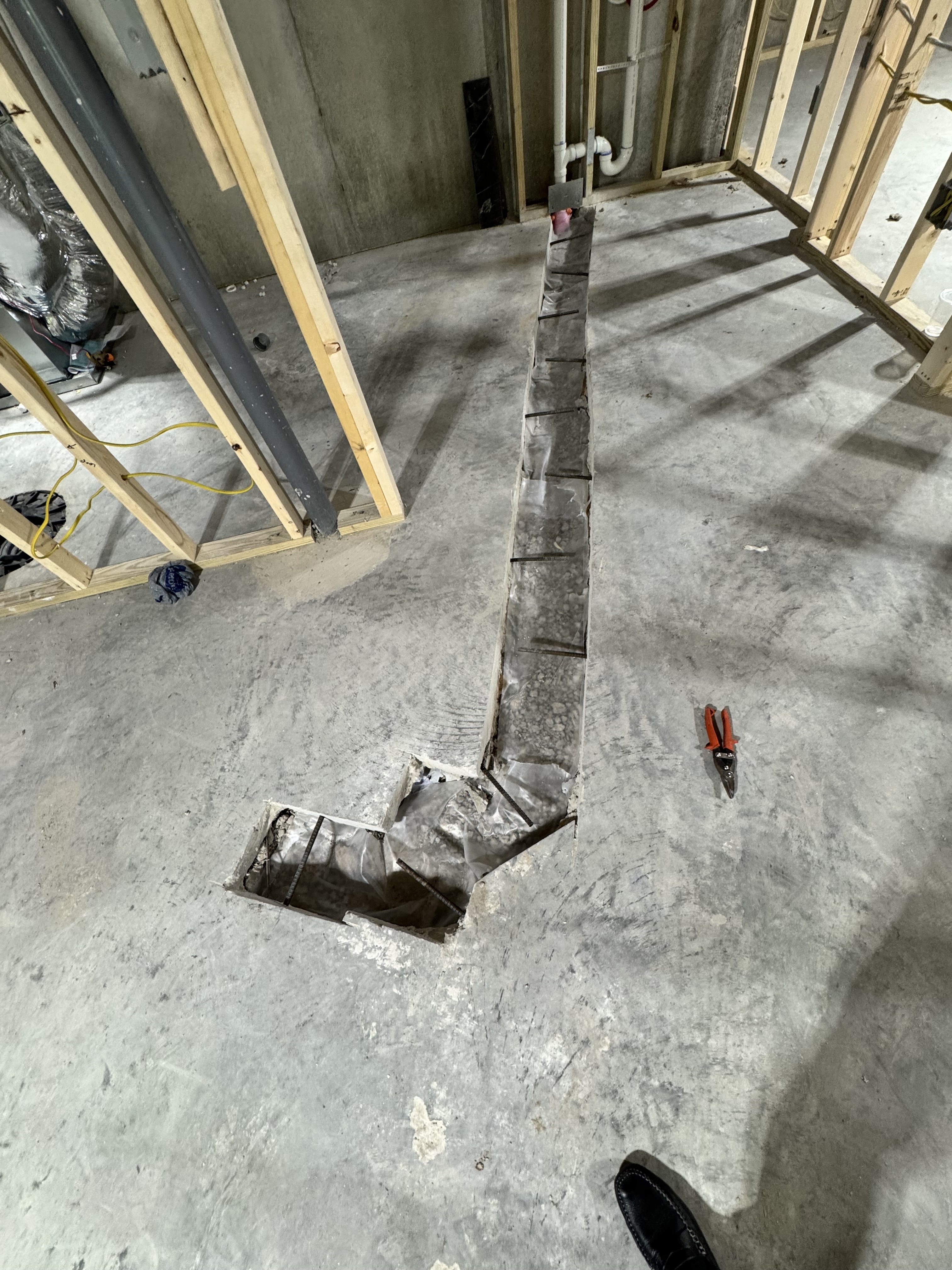 Basement plumbing trench work during Hawthorne remodel