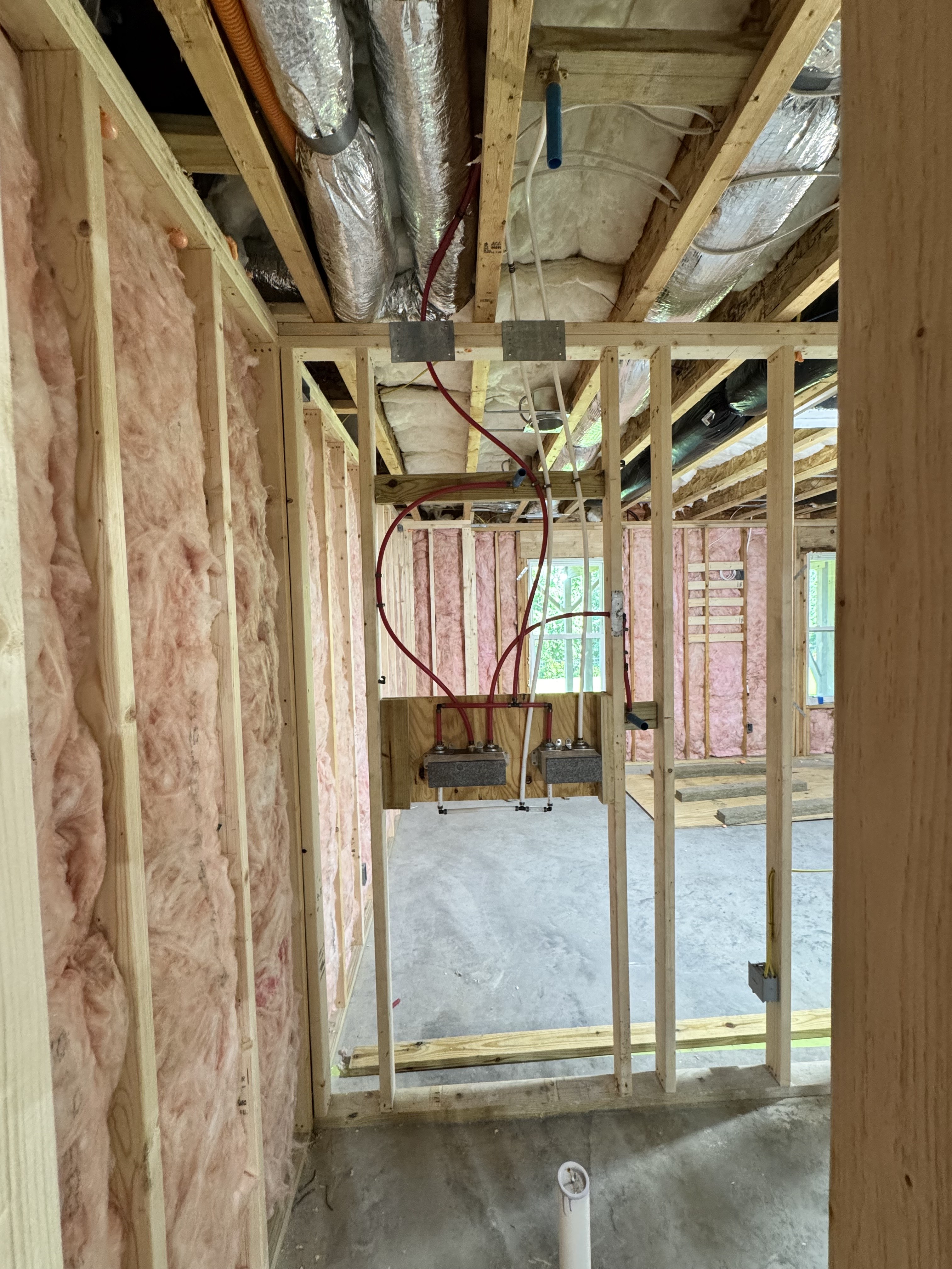 Framed basement rooms and rough-in progress in Apex
