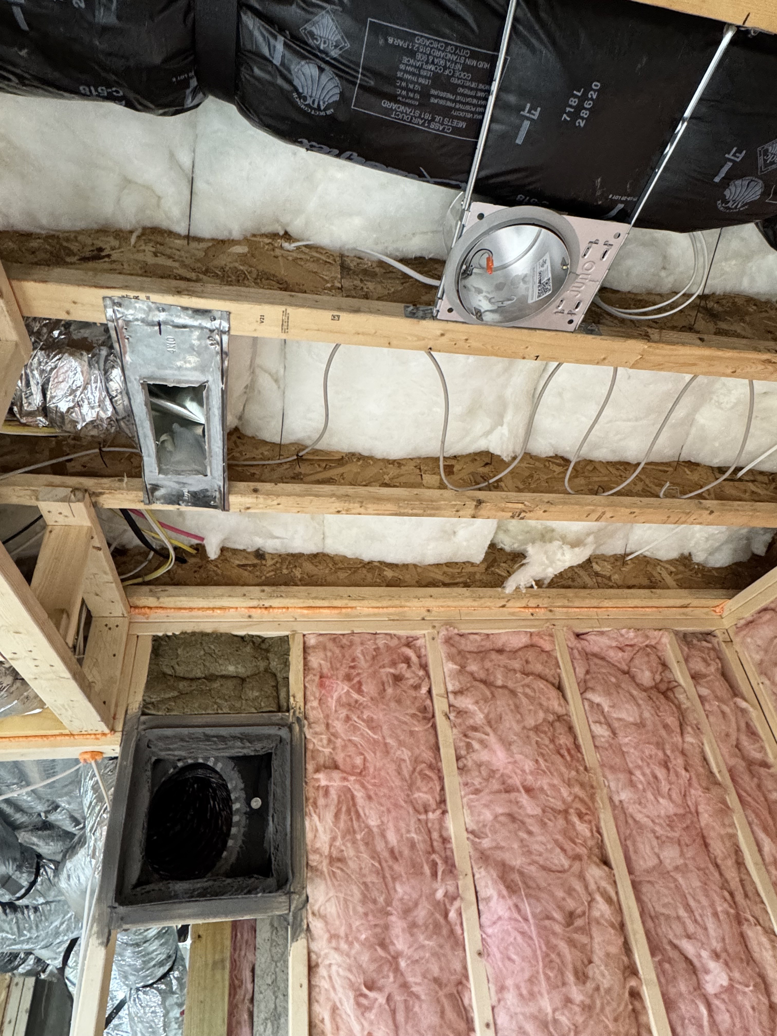 Basement ceiling insulation and HVAC rough-in progress
