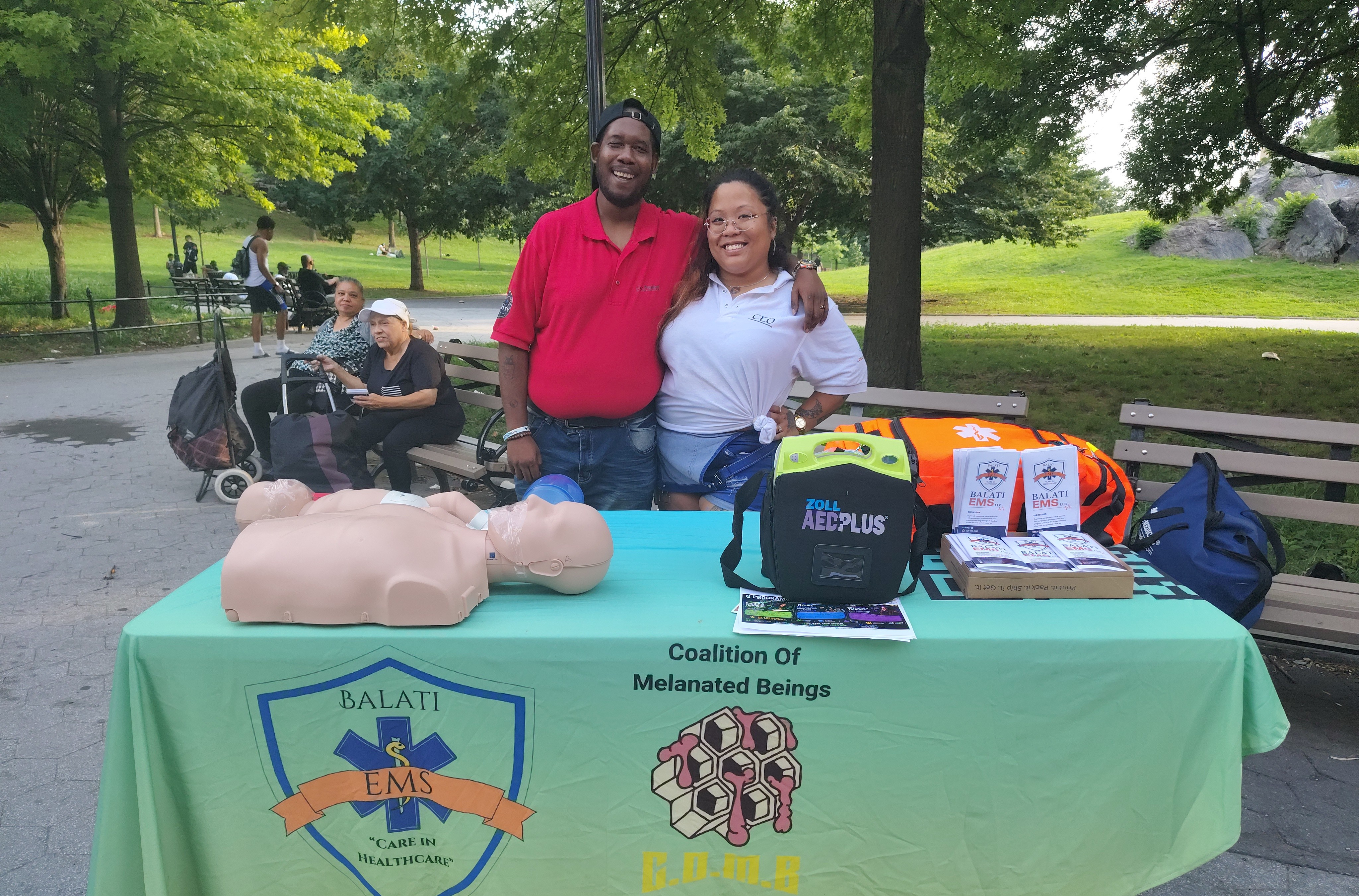 Balati EMS team at a community outreach table in the park