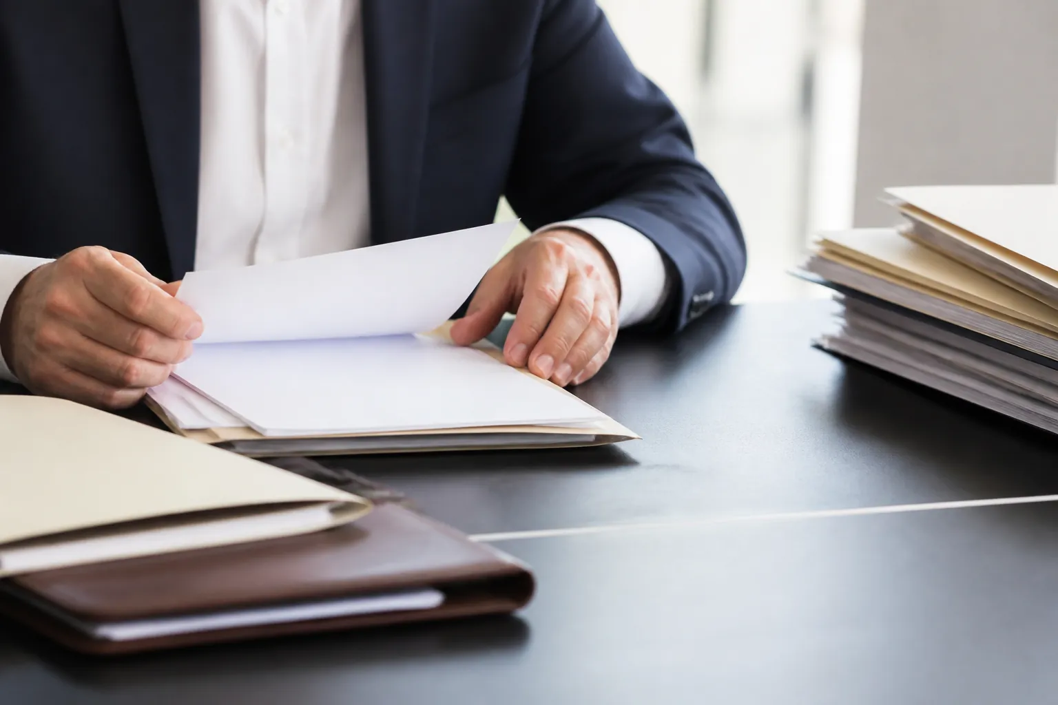 Finance professional reviewing blank documents and organizing files