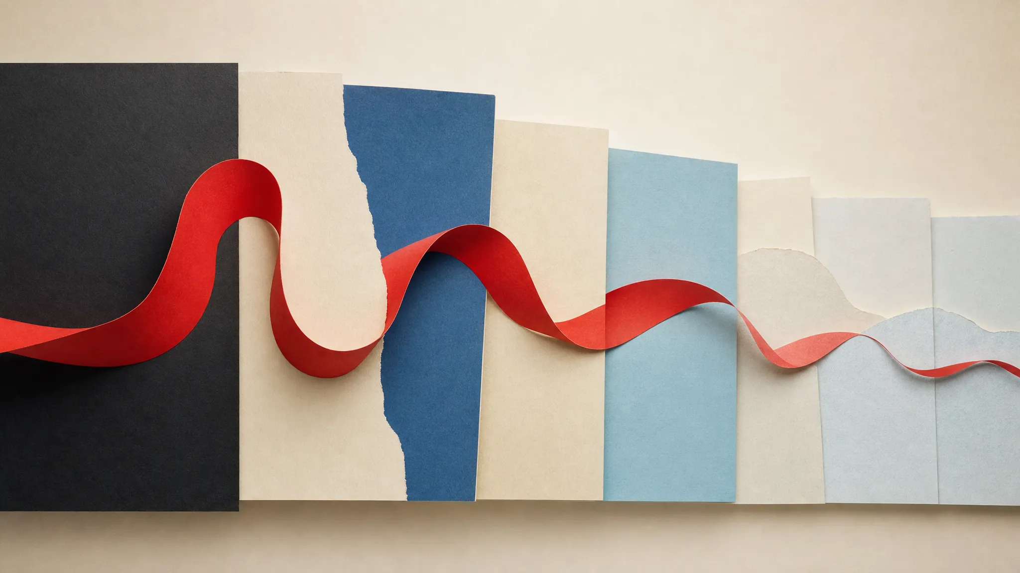 A continuous red paper ribbon moving across black, cream and blue panels