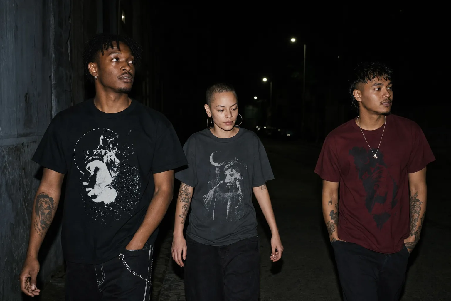 Friends wearing graphic streetwear under city streetlights