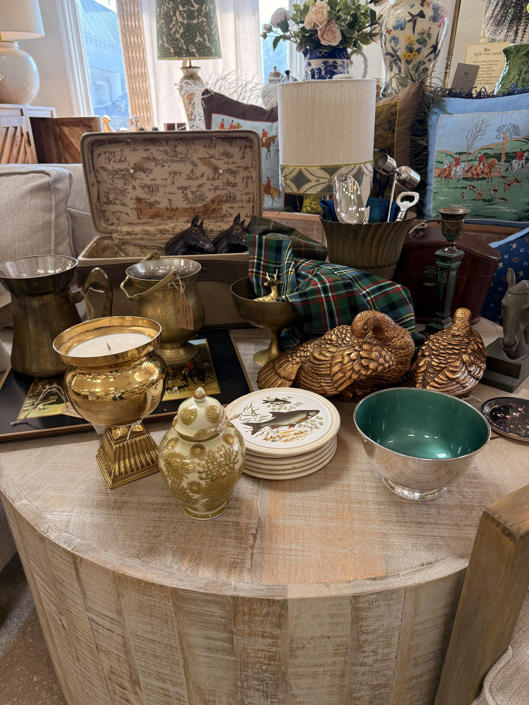Equestrian cushions, sporting plates, dog bookends, brass pieces, and a Hartmann train case at Re.
