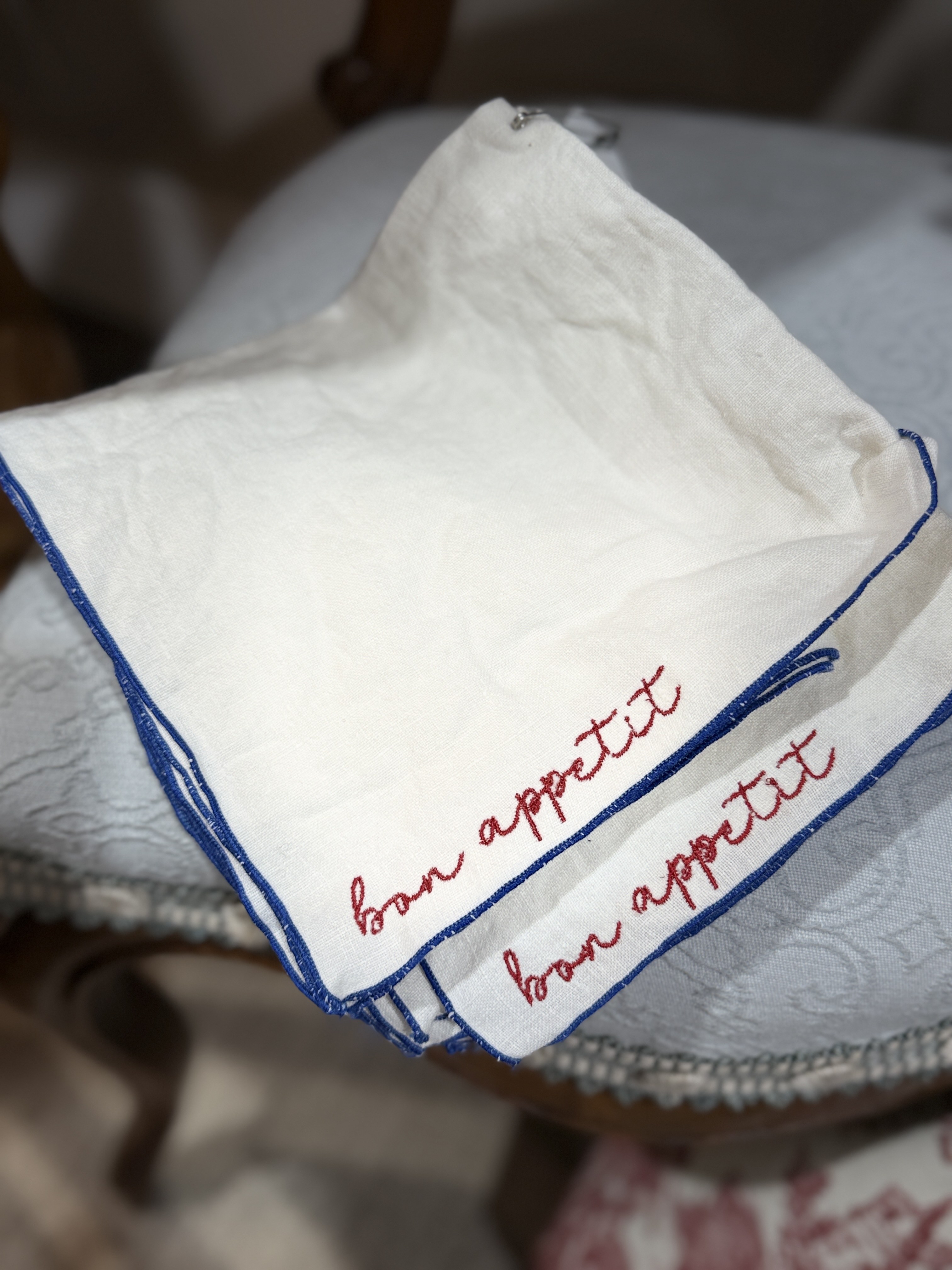 Embroidered linen cocktail napkins with blue trim