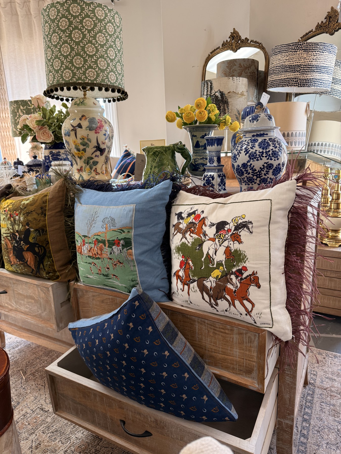 Equestrian cushions and blue-and-white porcelain in a Re. display