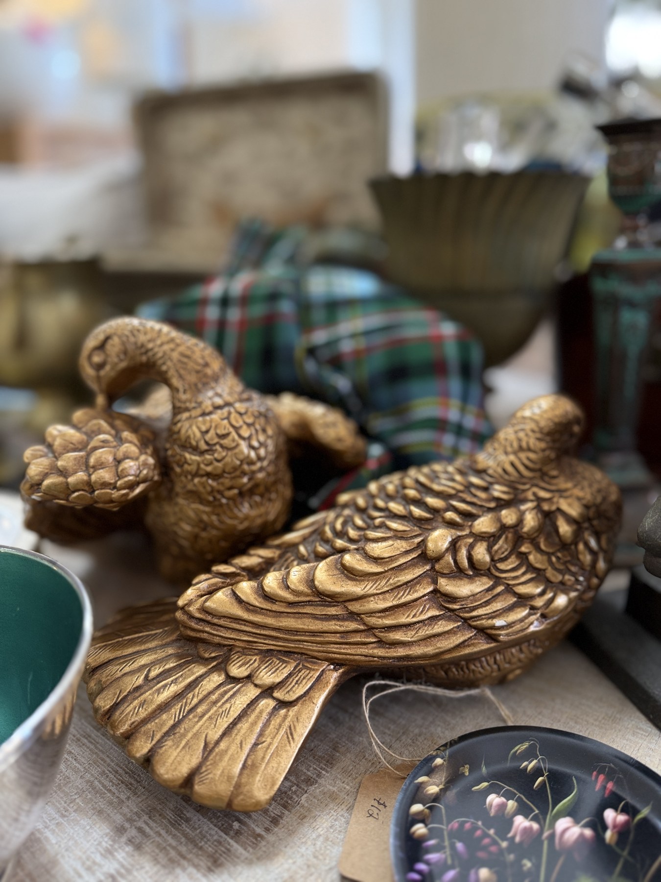 Pair of aged brass duck figures on a table