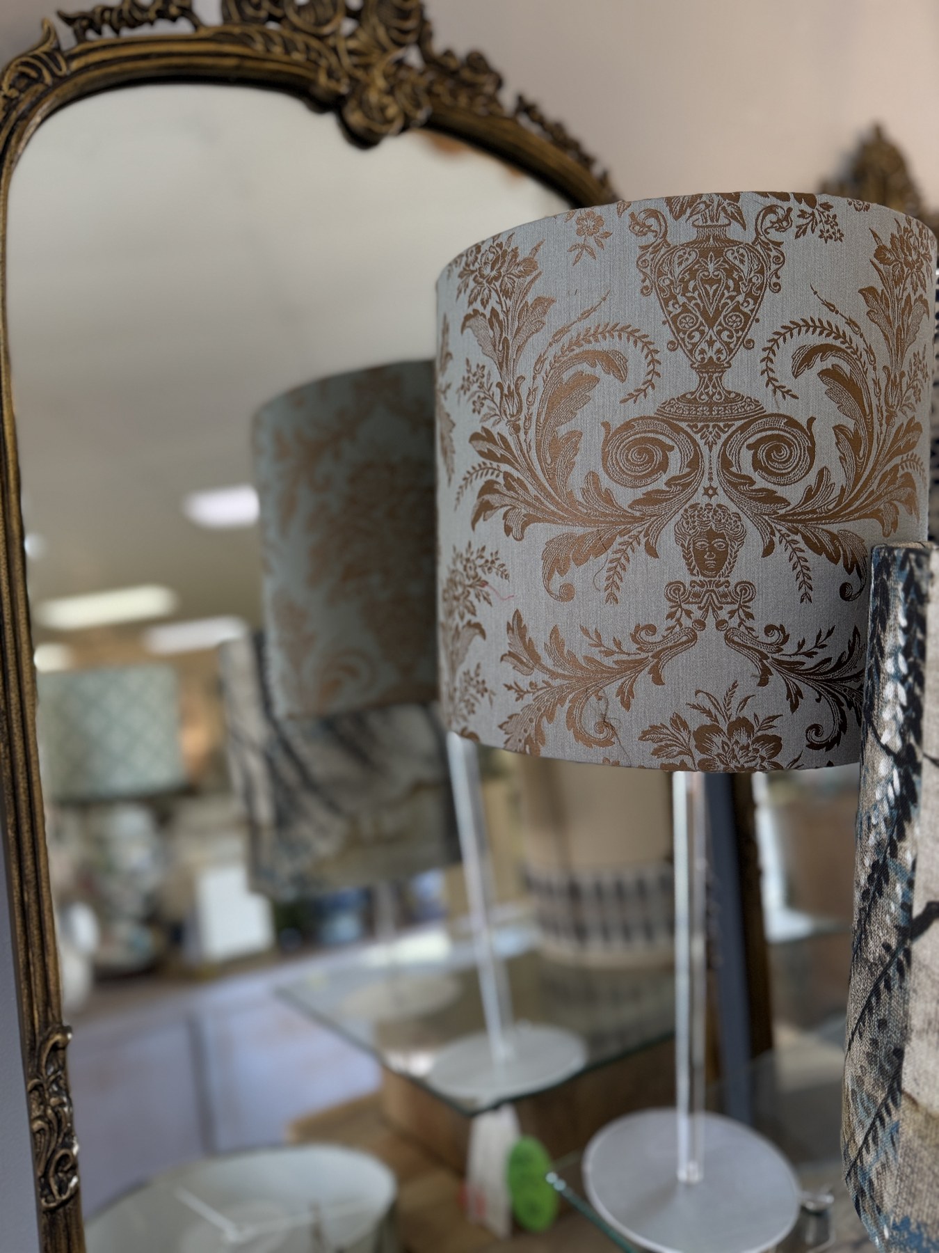 Tailored patterned lampshade in front of a vintage mirror