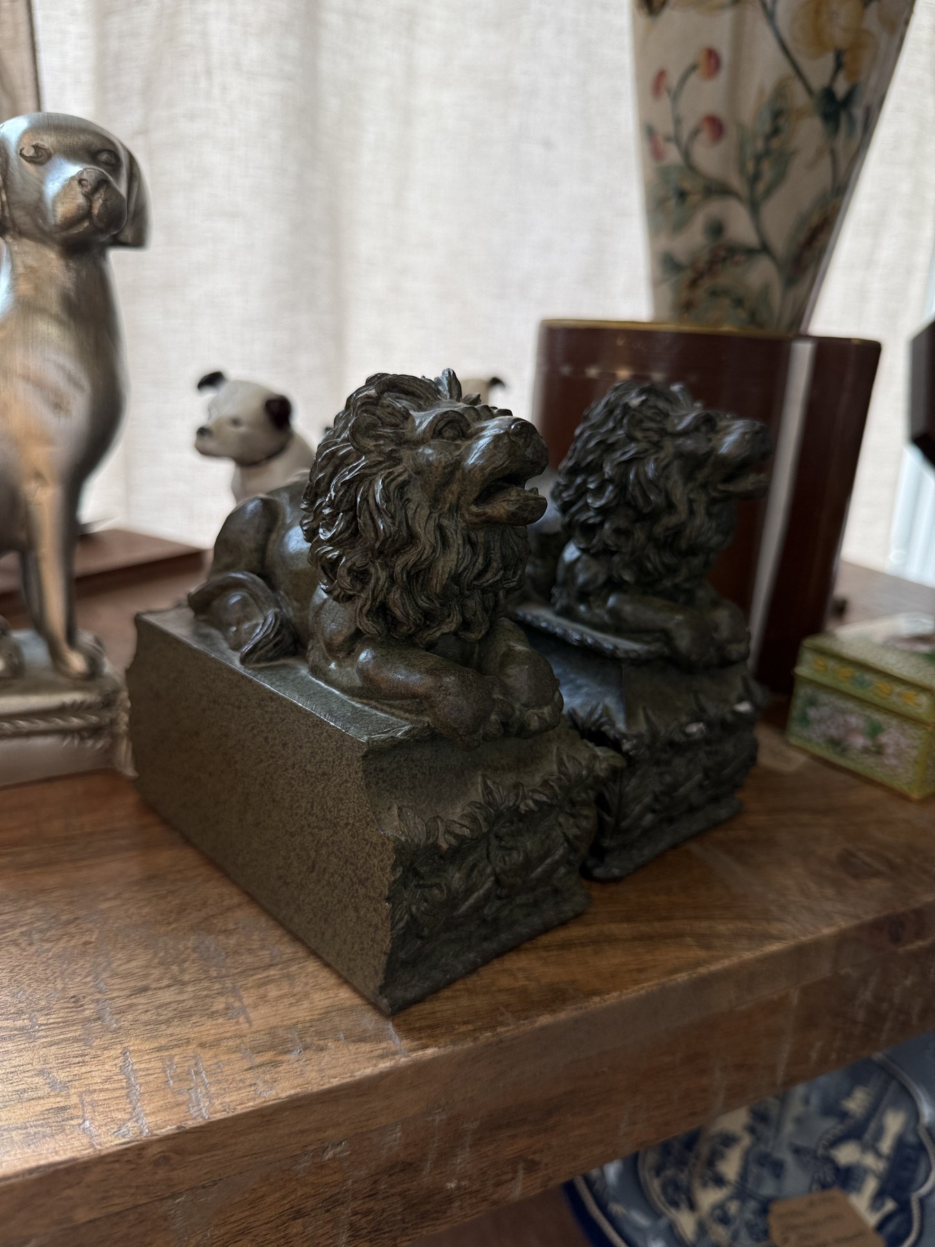 Vintage dog bookends on a wood shelf