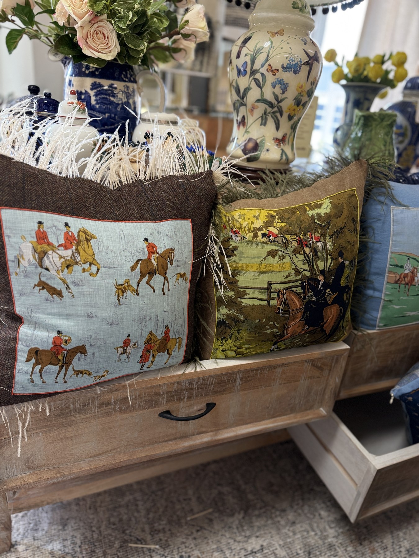Horse cushions and sporting objects styled in a vintage wooden bench