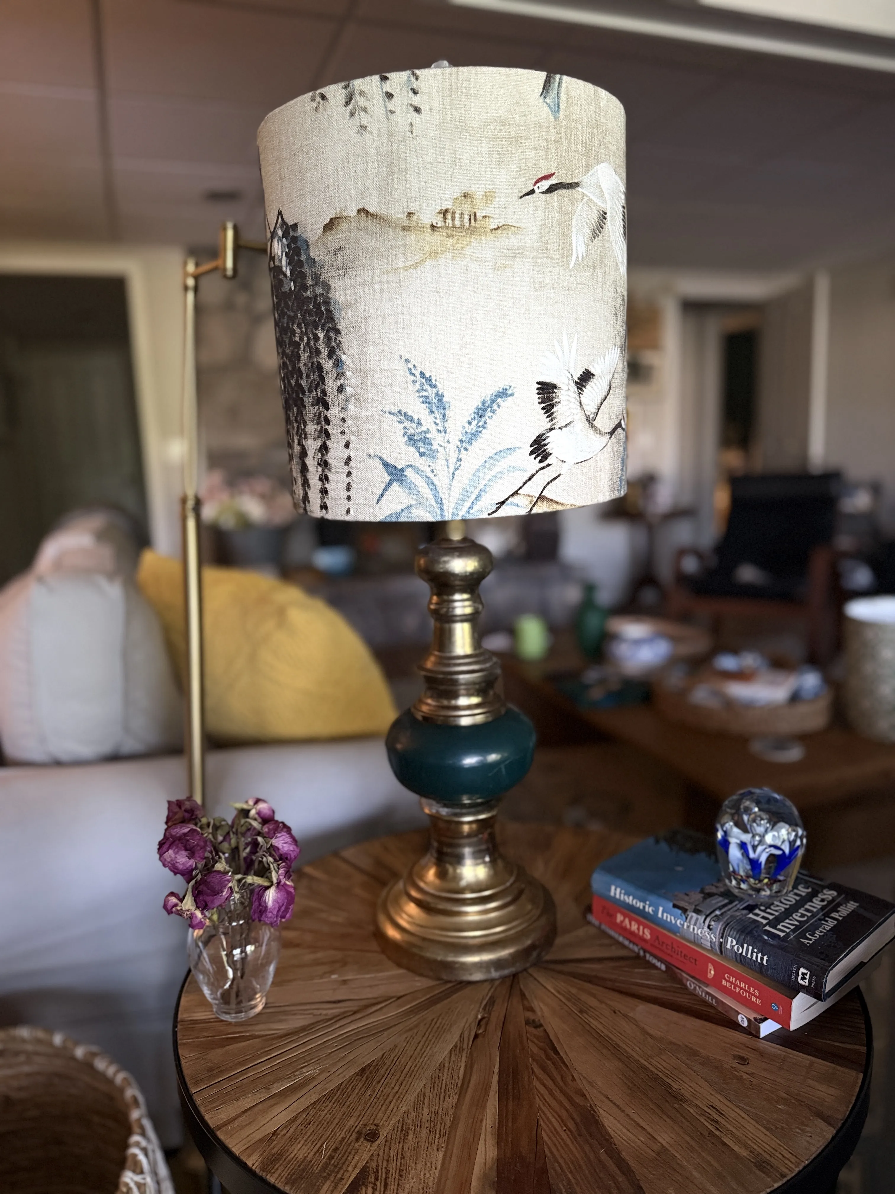 Restored brass table lamp with an emerald and crane-patterned shade
