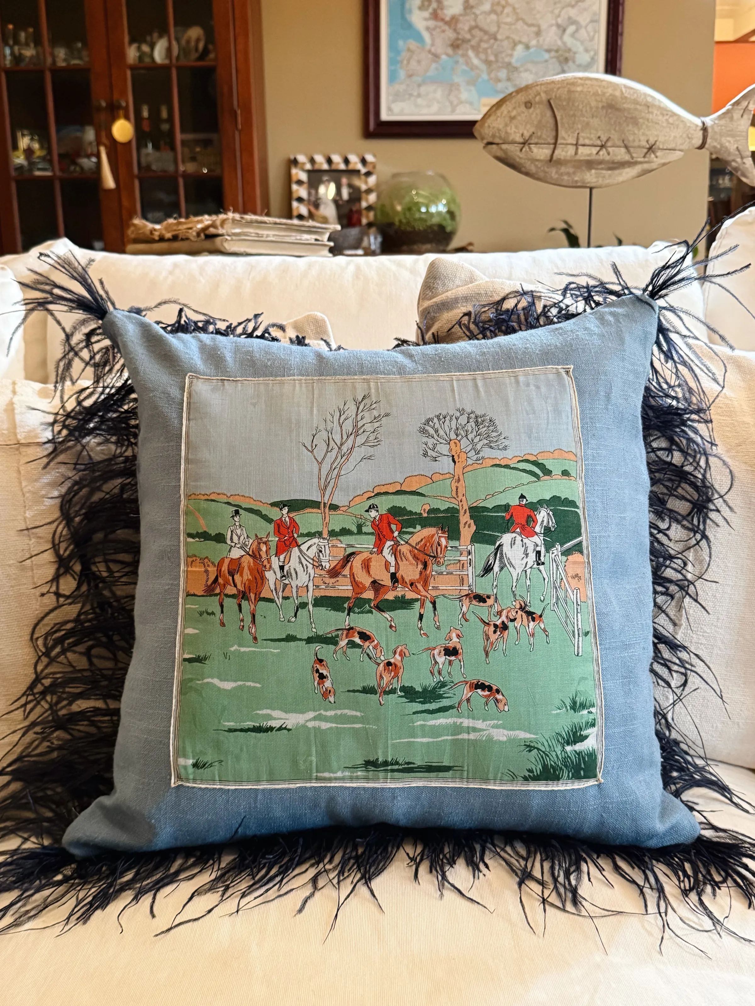 Vintage equestrian textile cushion layered into a collected home