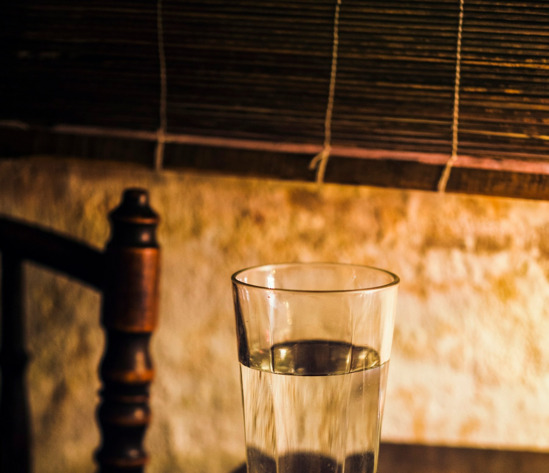 A glass of plain water on a table before a fasting blood test