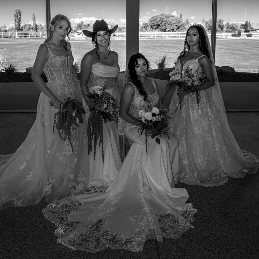 Four bridal models in wedding gowns holding bouquets at Magnolia Reserve, photographed in black and white