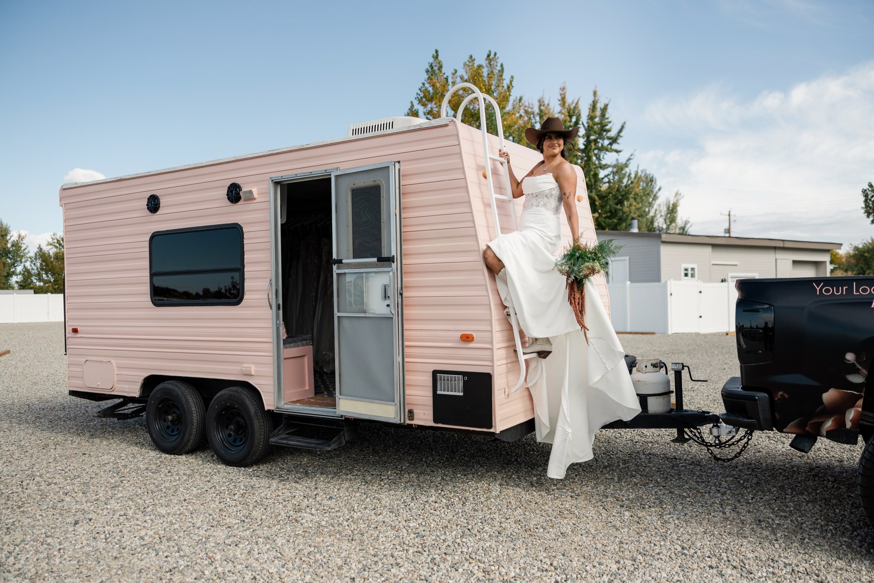 The pink Bustle mobile bridal suite with a bride beside its open doorway