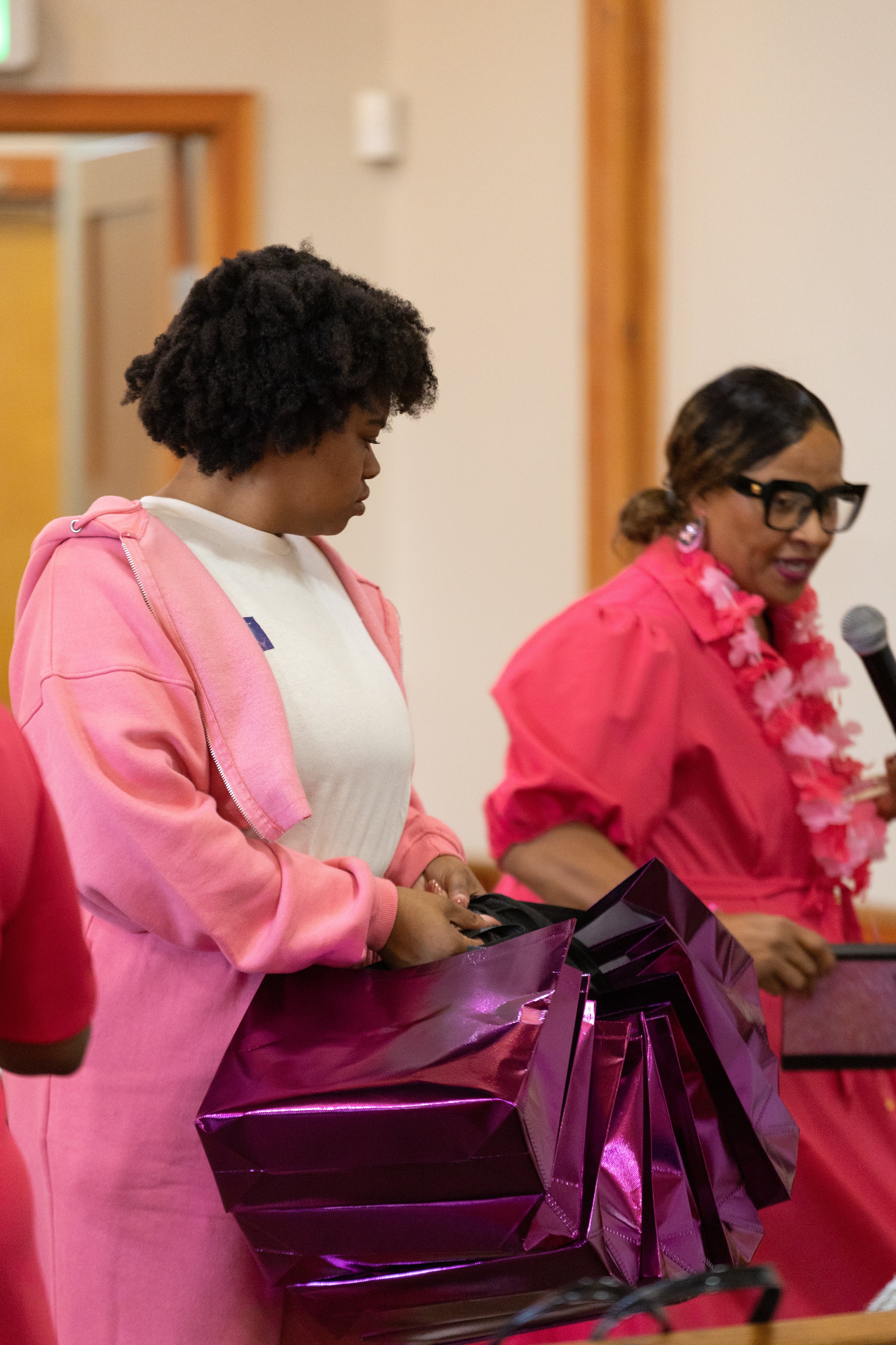 A Daw of a New Day community member preparing a gift bag at a cancer awareness gathering