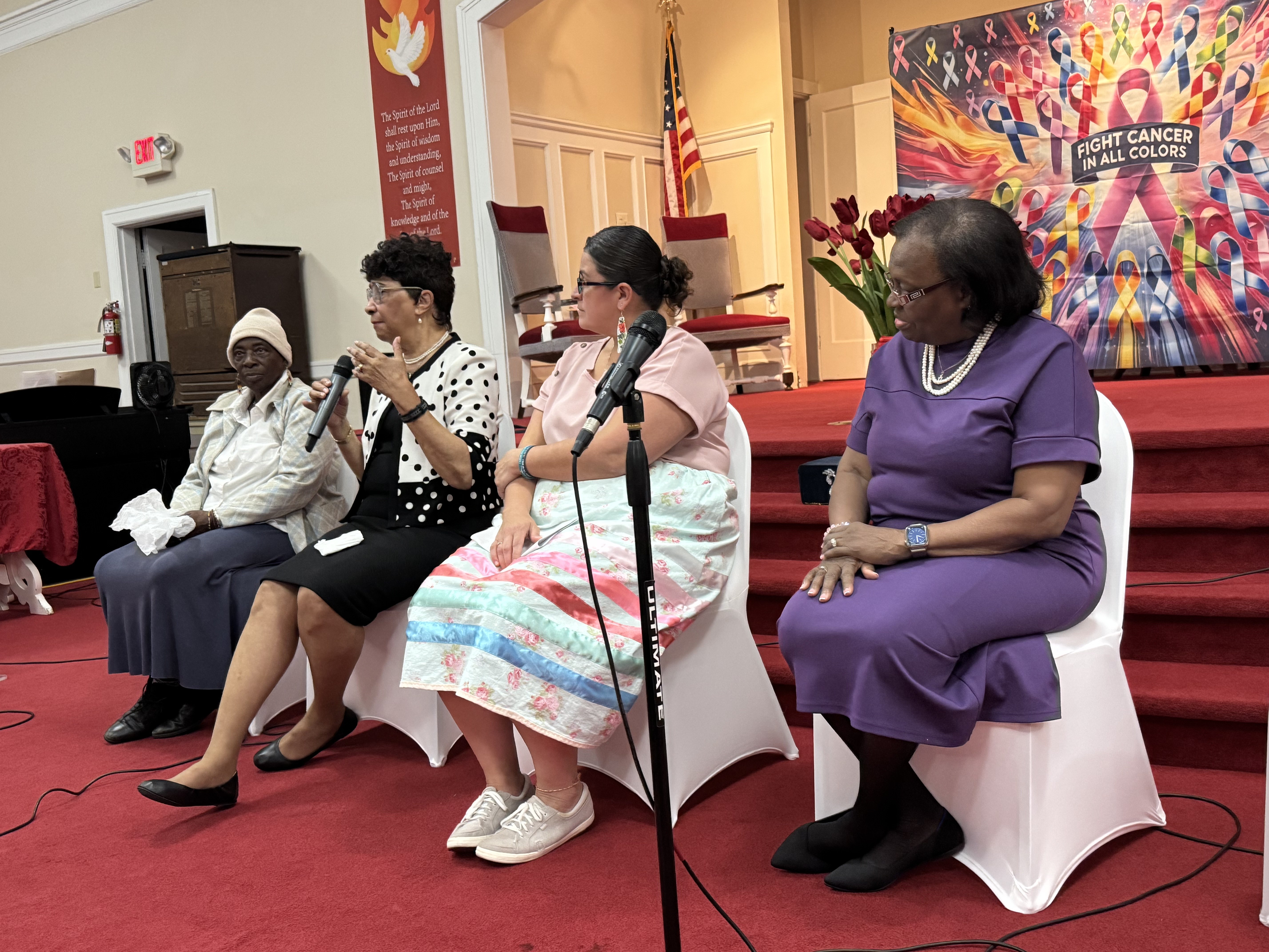 Community members sharing a conversation at a Daw of a New Day cancer awareness gathering