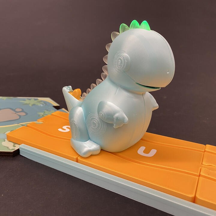 Dash the Dino standing on the alphabet path