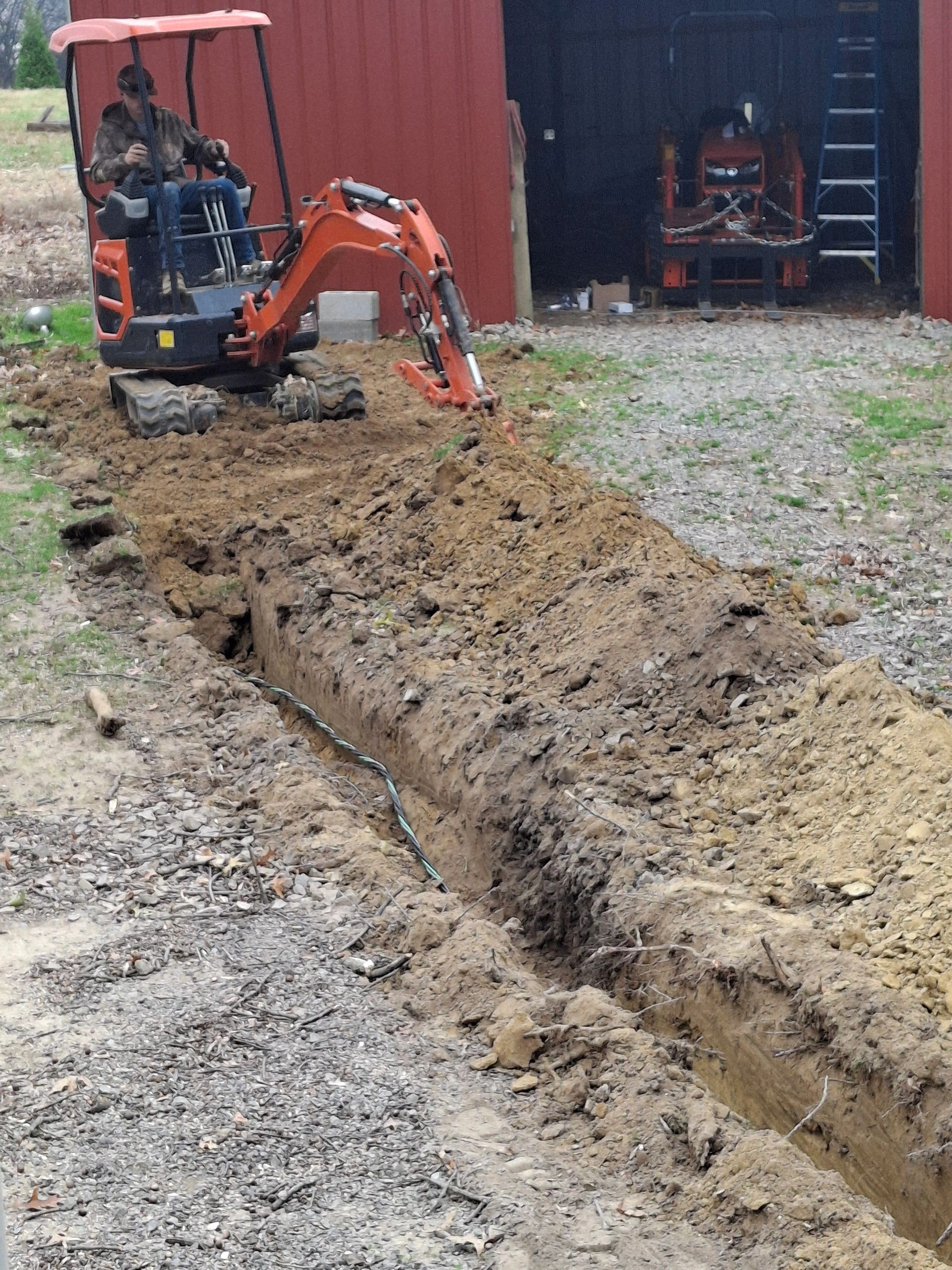 Utility work underway beside the barn at New Sentinel Acres