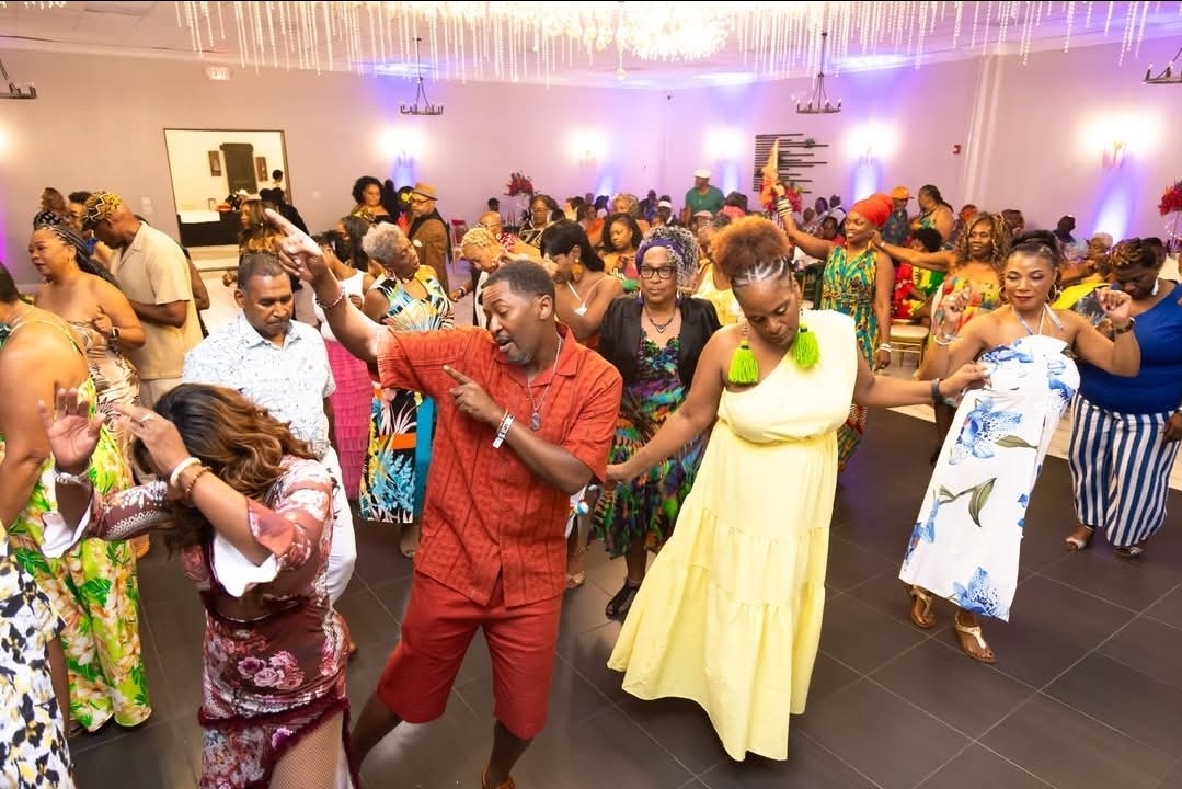 Guests dancing together at a brightly lit celebration