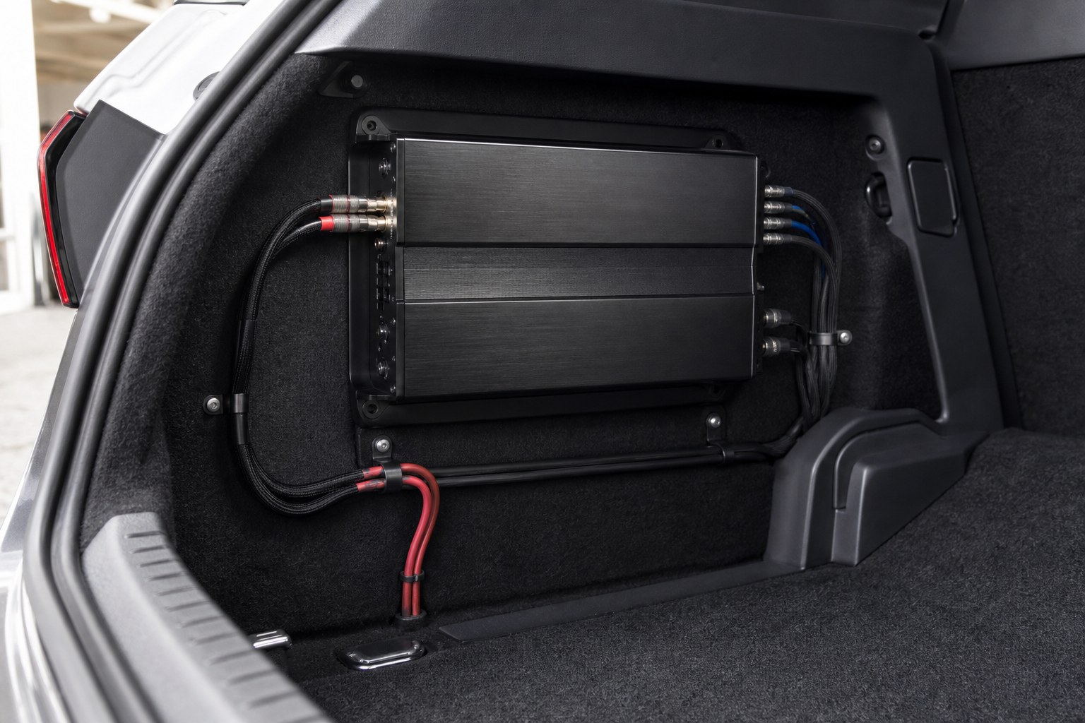 Neatly mounted car audio amplifier with professionally routed cables