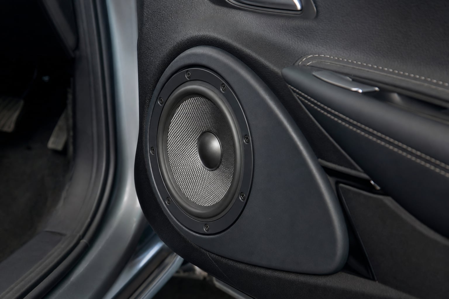 Aftermarket door speaker fitted cleanly into a vehicle