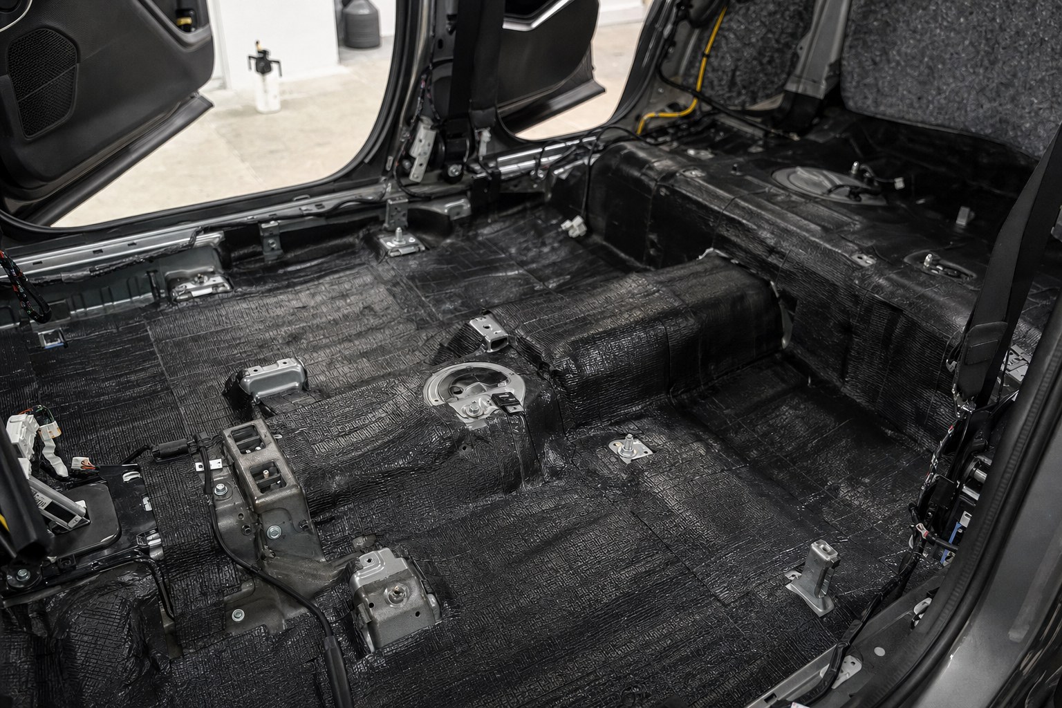 Vehicle floor fitted with sound-deadening material during a professional installation