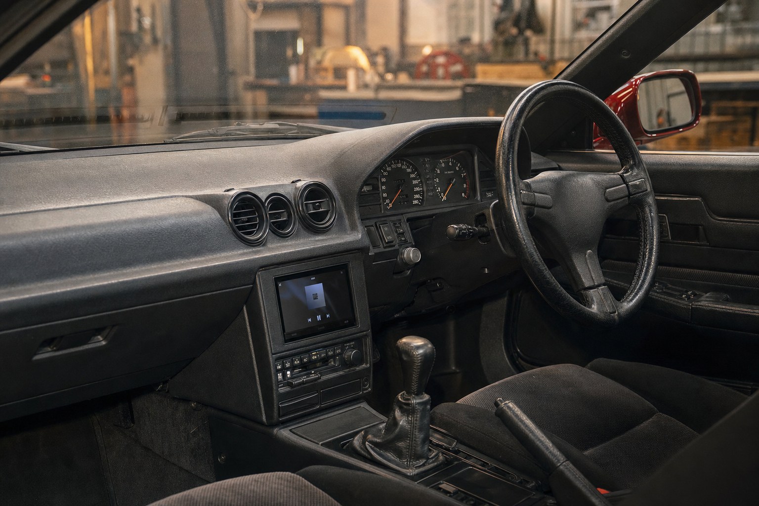 Classic Japanese sports coupe dashboard with discreet modern audio integration