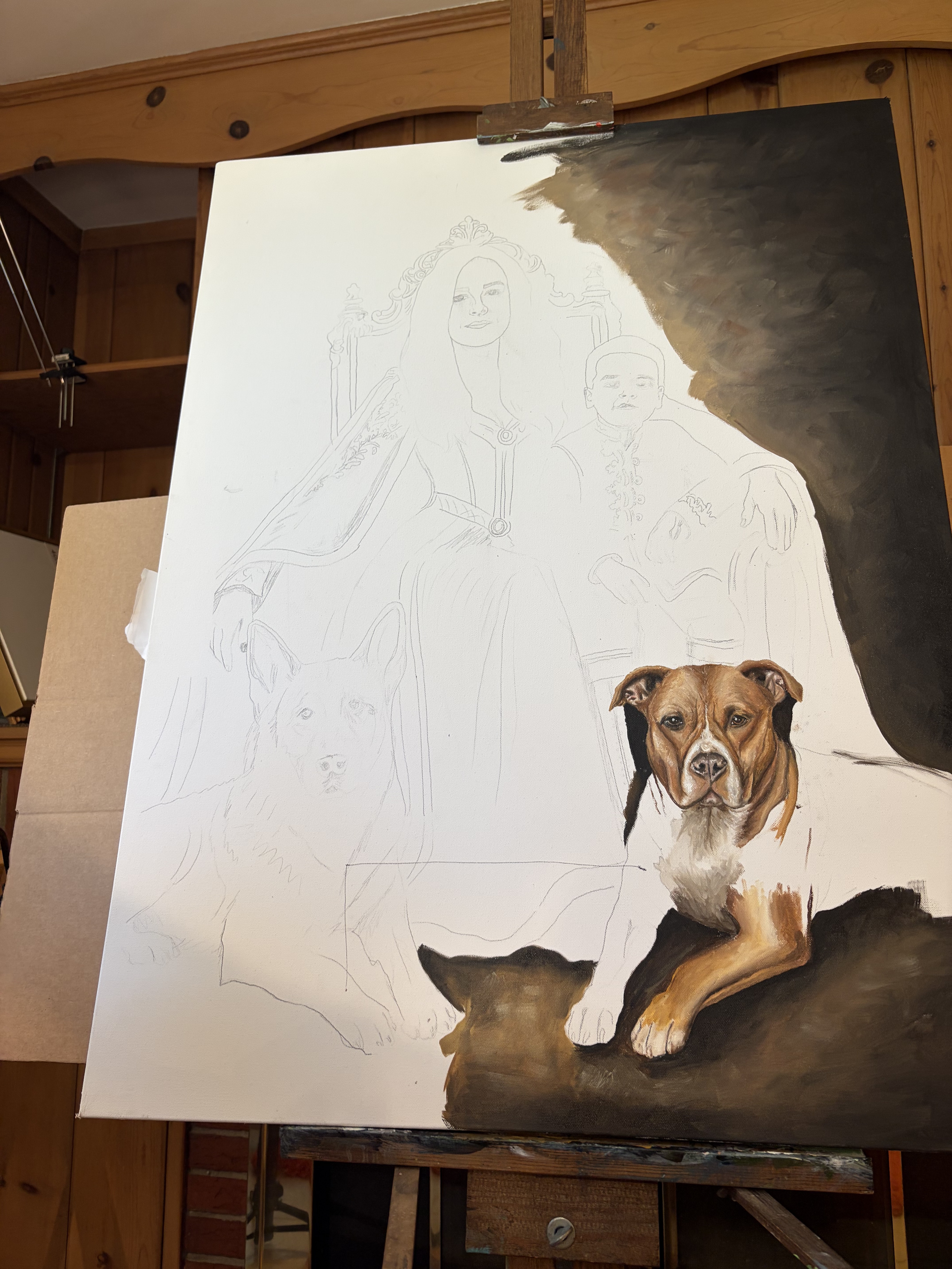 A large family oil painting in progress, with a dog portrait already painted into the canvas