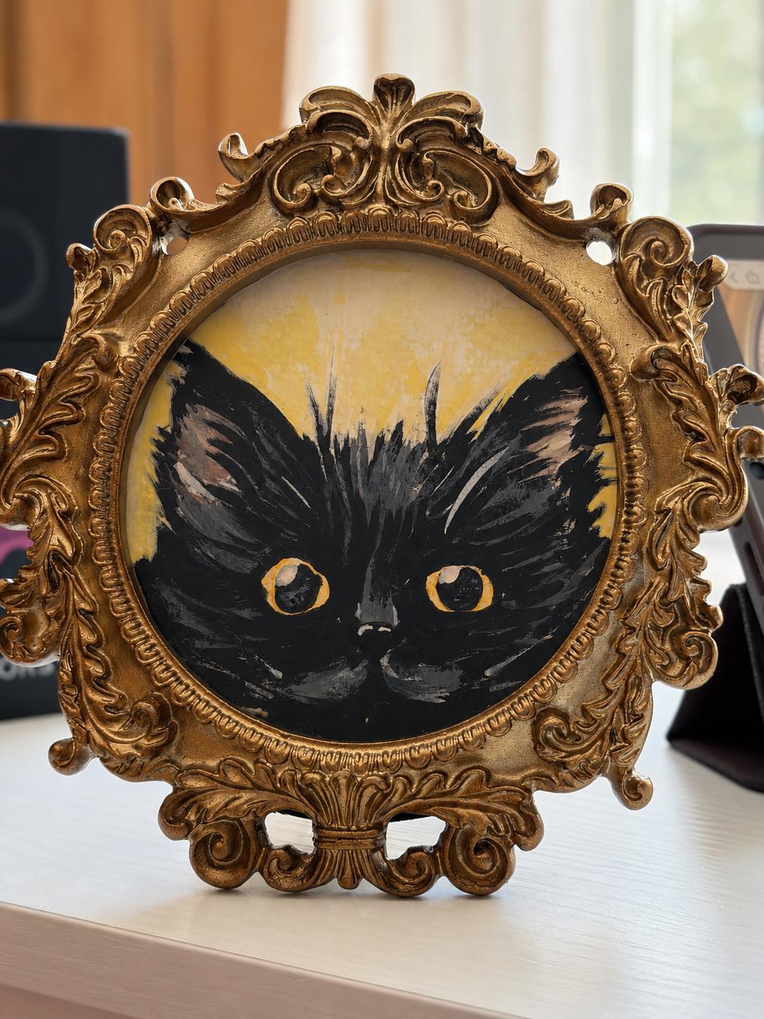 Black cat in miniature frame