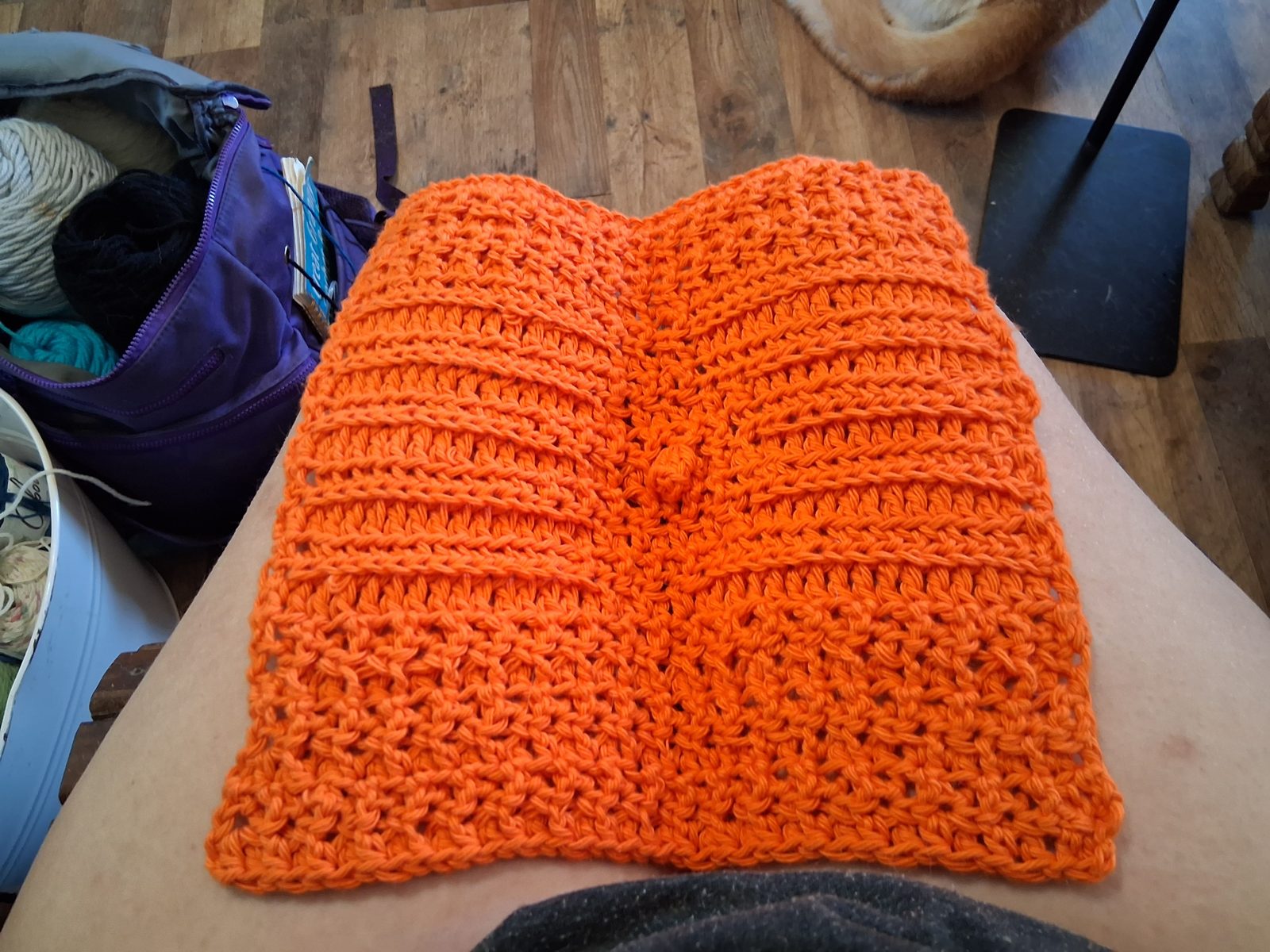 Orange crocheted dishcloth with a raised diamond puff texture