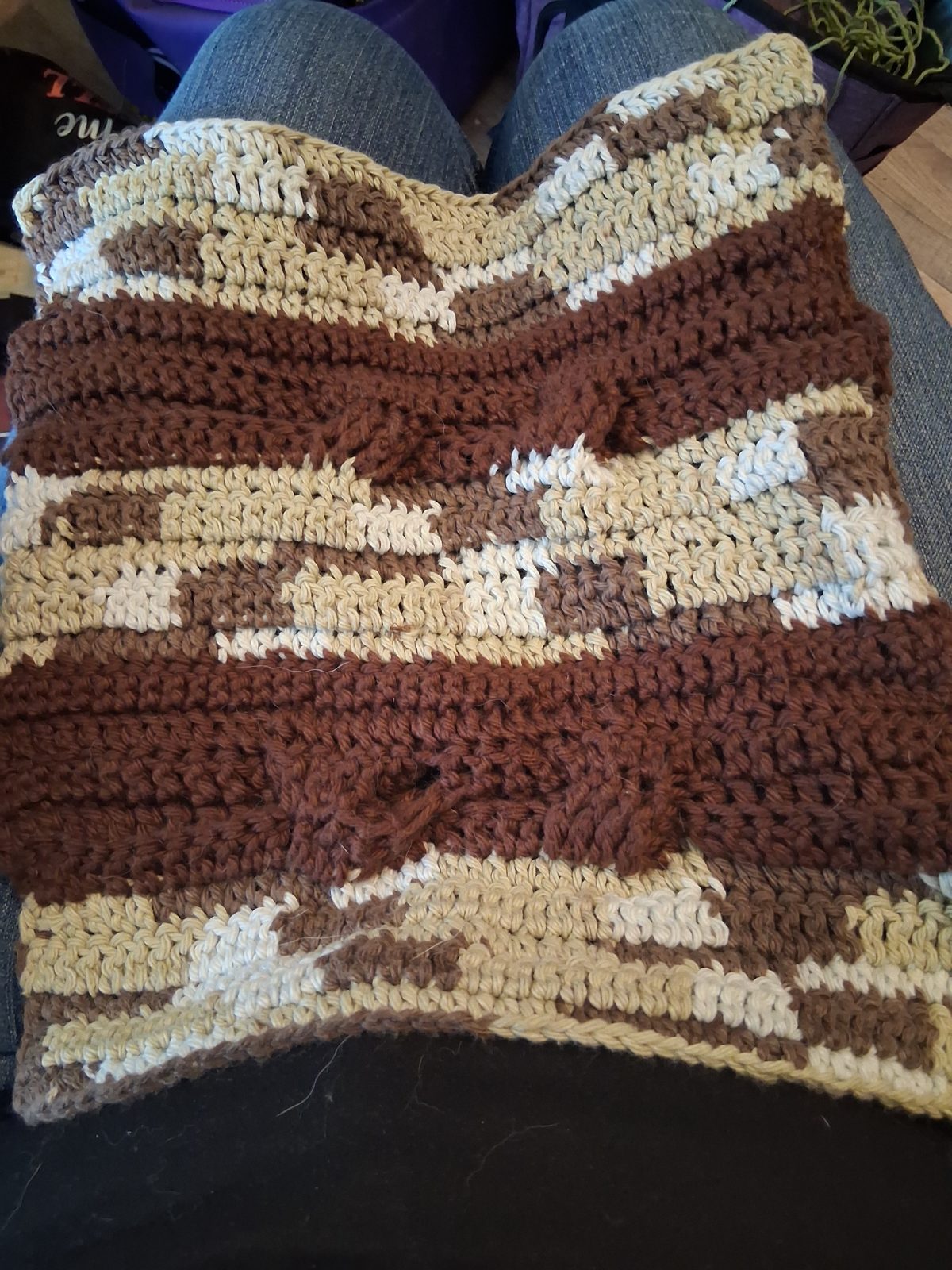 Crocheted dishcloth with raised brown cables and cream and tan stripes