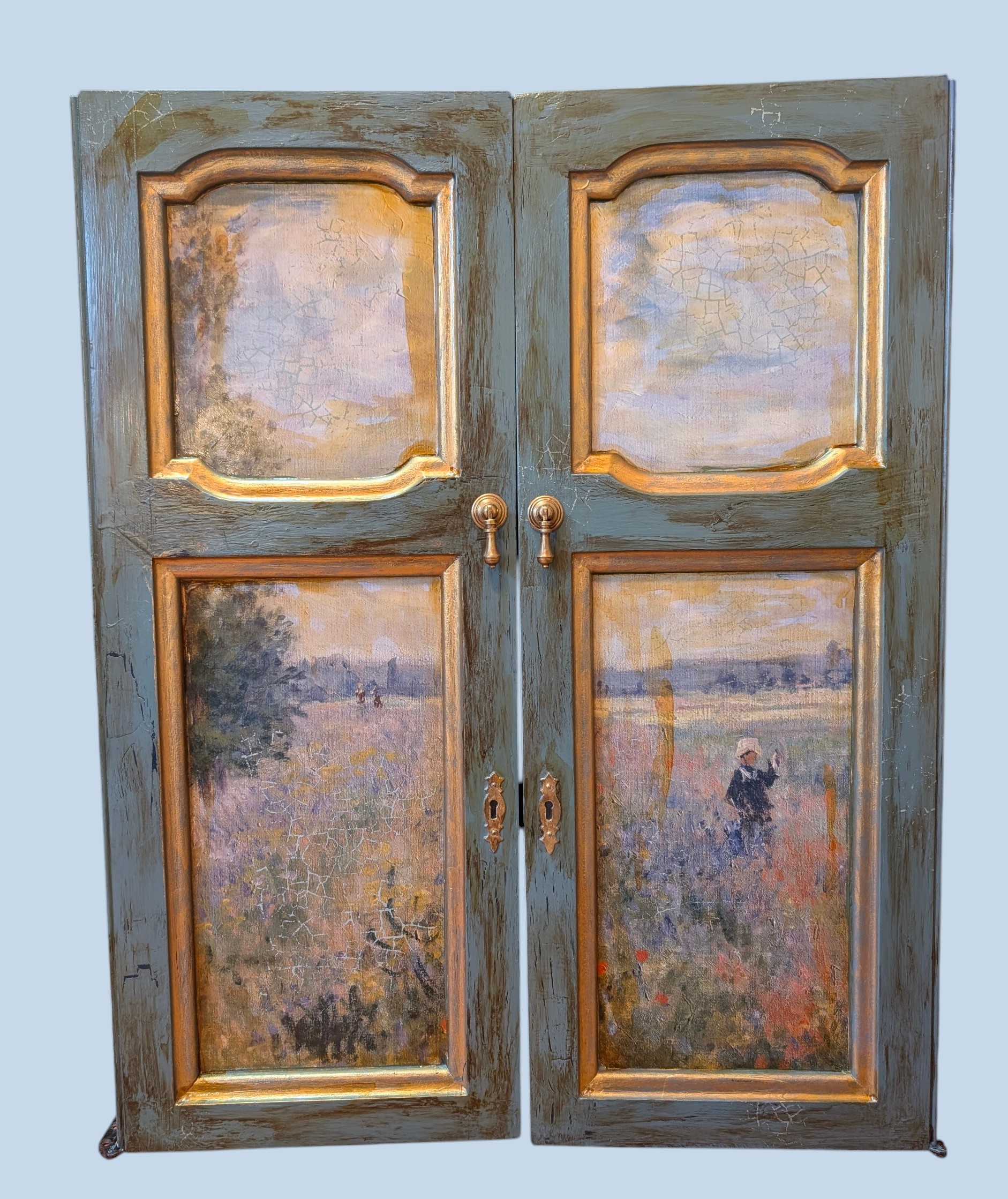 A pair of cabinet doors transformed with a painterly landscape decoupage