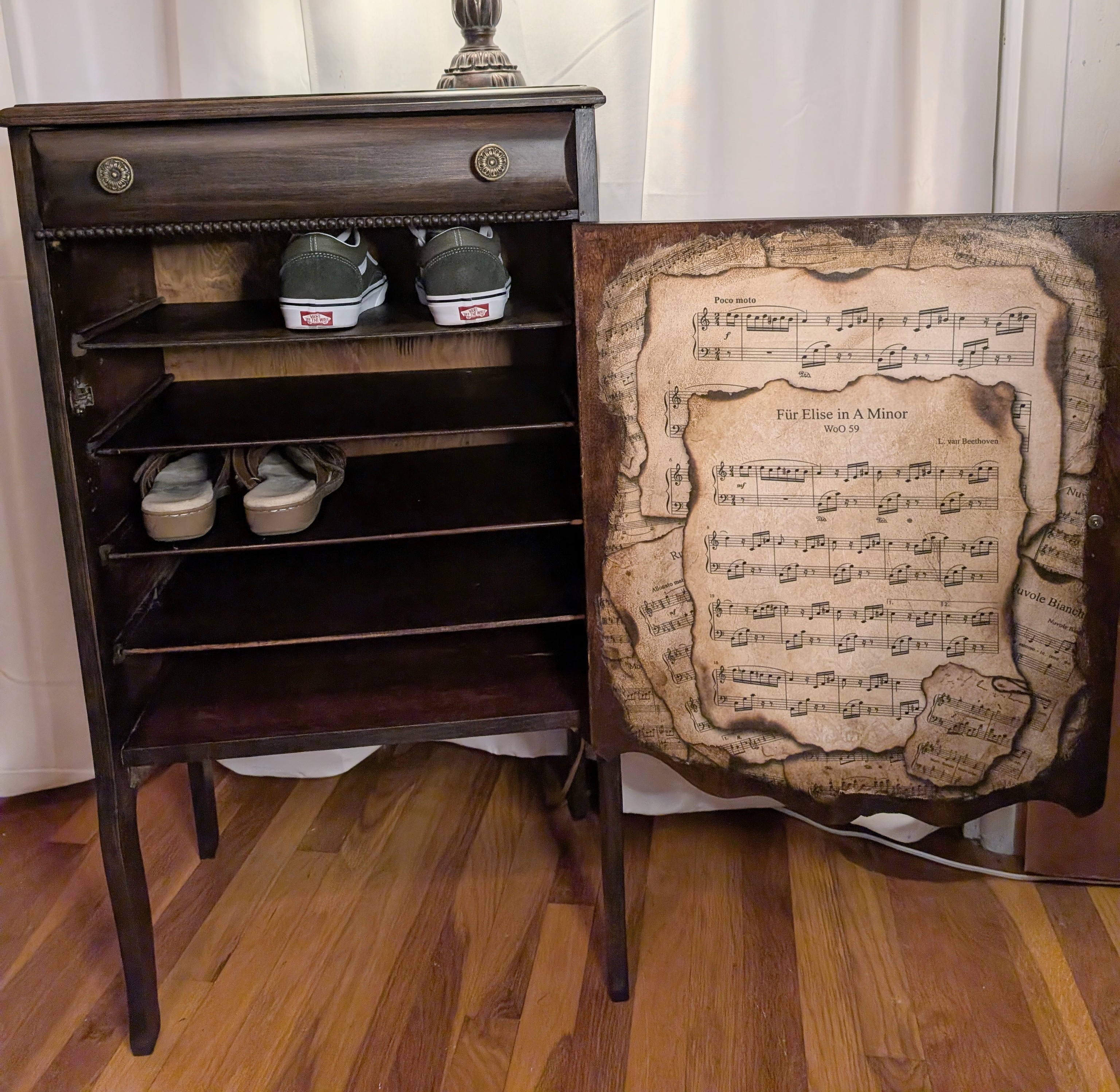 Vintage cabinet door detailed with sheet music decoupage