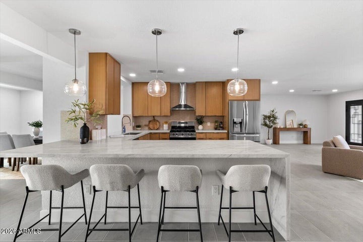 Kitchen at 3926 E Laurel Ln, with wood cabinets and island seating