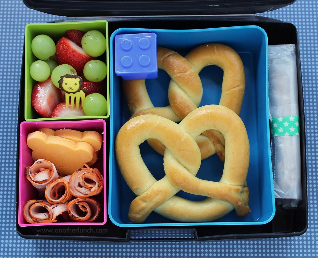 Laptop Lunches bento lunch: soft pretzels, Lego sauce container, homemade chocolate chip granola bar