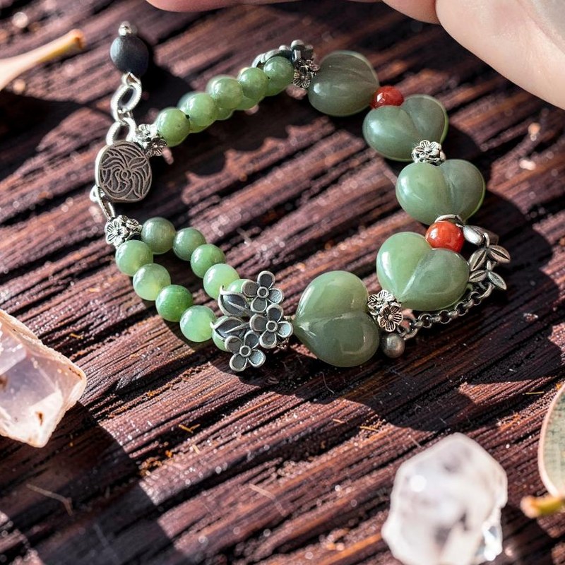 Green jade heart bracelet with silver floral accents