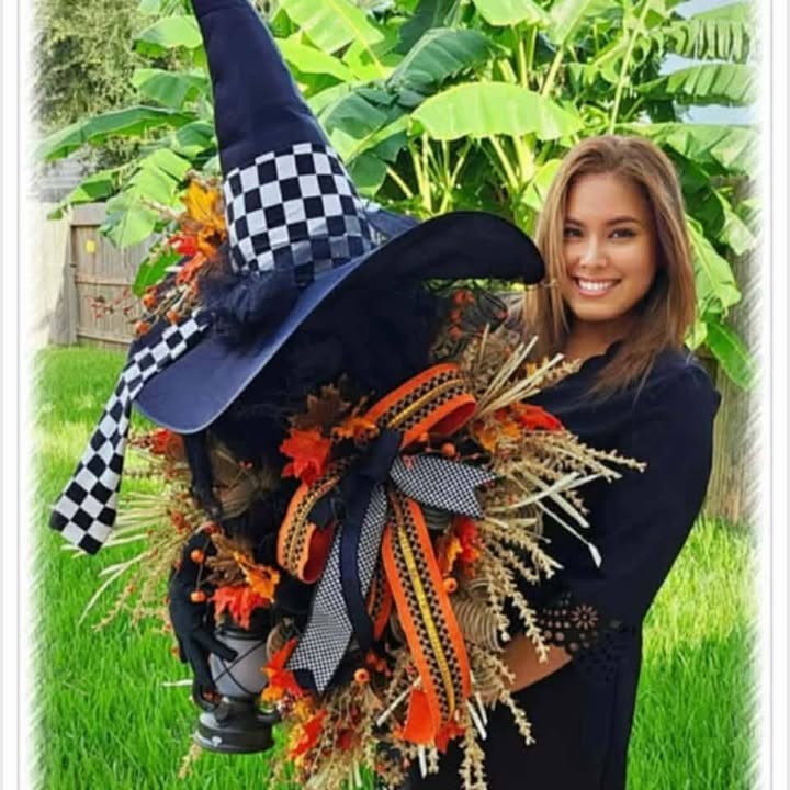 Karla Montalvan Rios holding a handmade witch wreath