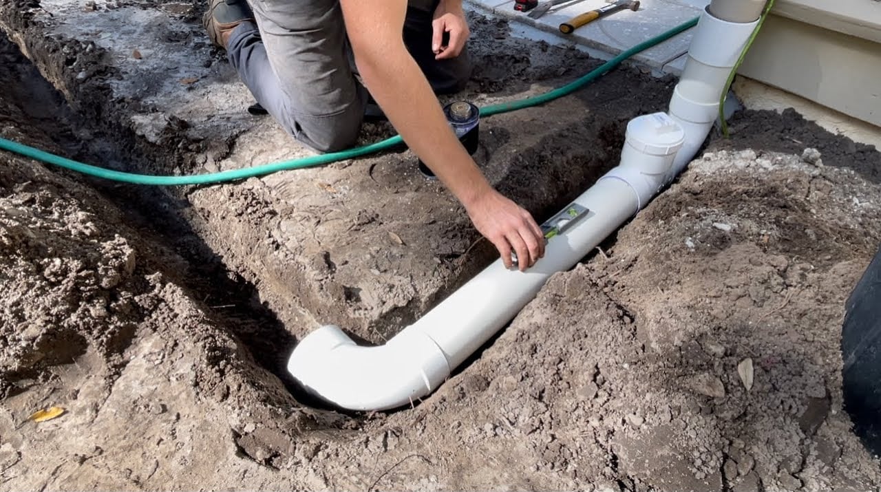 Crown & Cross installing underground drainage pipe at a Dothan, Alabama home
