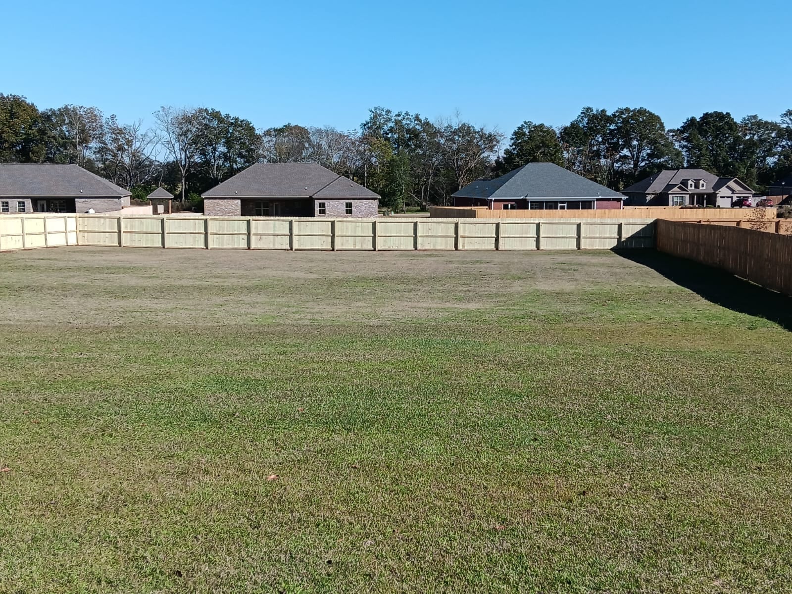 Completed wood privacy fence at a Daleville, Alabama home