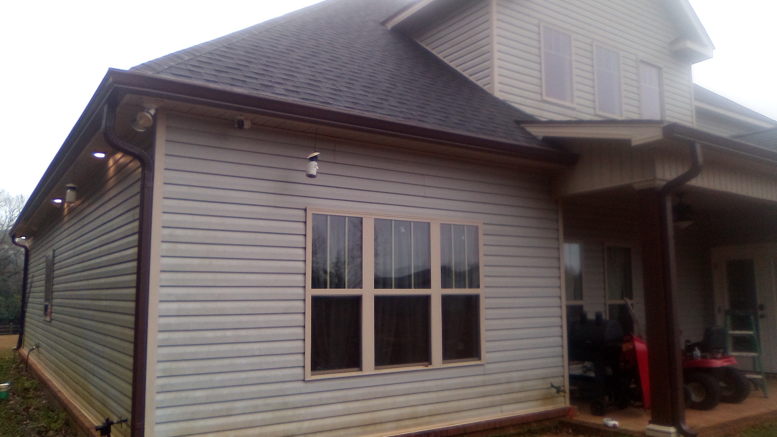 Brown seamless gutters installed on a home