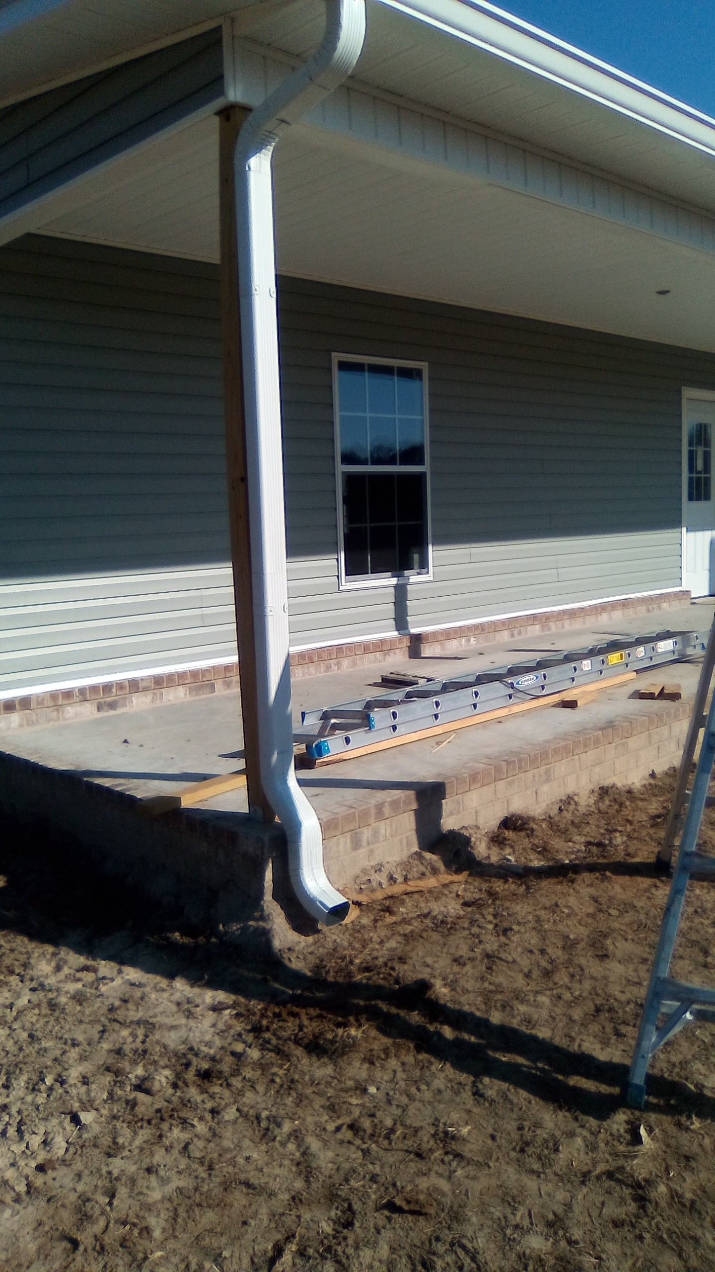 White downspout installed at a residential home